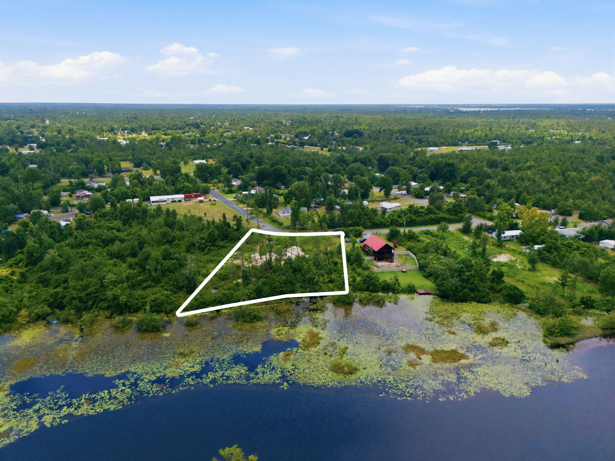 Waterfront opportunity on Bear Creek. This .775-acre residential lot at 9802 Creek Bank Drive in Youngstown, Florida, offers direct water access and serene water views in a natural setting.
Positioned along Bear Creek, the property provides an appealing setting for boating, kayaking, fishing, and other water-based recreation. With approximately three-quarters of an acre, the lot offers ample space to design and build a custom residence, subject to all applicable county and state regulations. Adding significant value and convenience, building plans are included with the lot purchase. The property is currently land-only, allowing a future owner to use the provided plans or develop an improvement strategy tailored to their needs.
The location combines a quiet, creekfront environment with access to the broader Panama City and Bay County region. Area roadways connect Youngstown to nearby services, shopping, dining, and Gulf Coast attractions, making this site suitable for a primary residence, second home, or long-term hold.
This Bear Creek lot is offered for sale as-is, presenting a rare chance to secure waterfront land with both views and direct access in a growing Northwest Florida market.