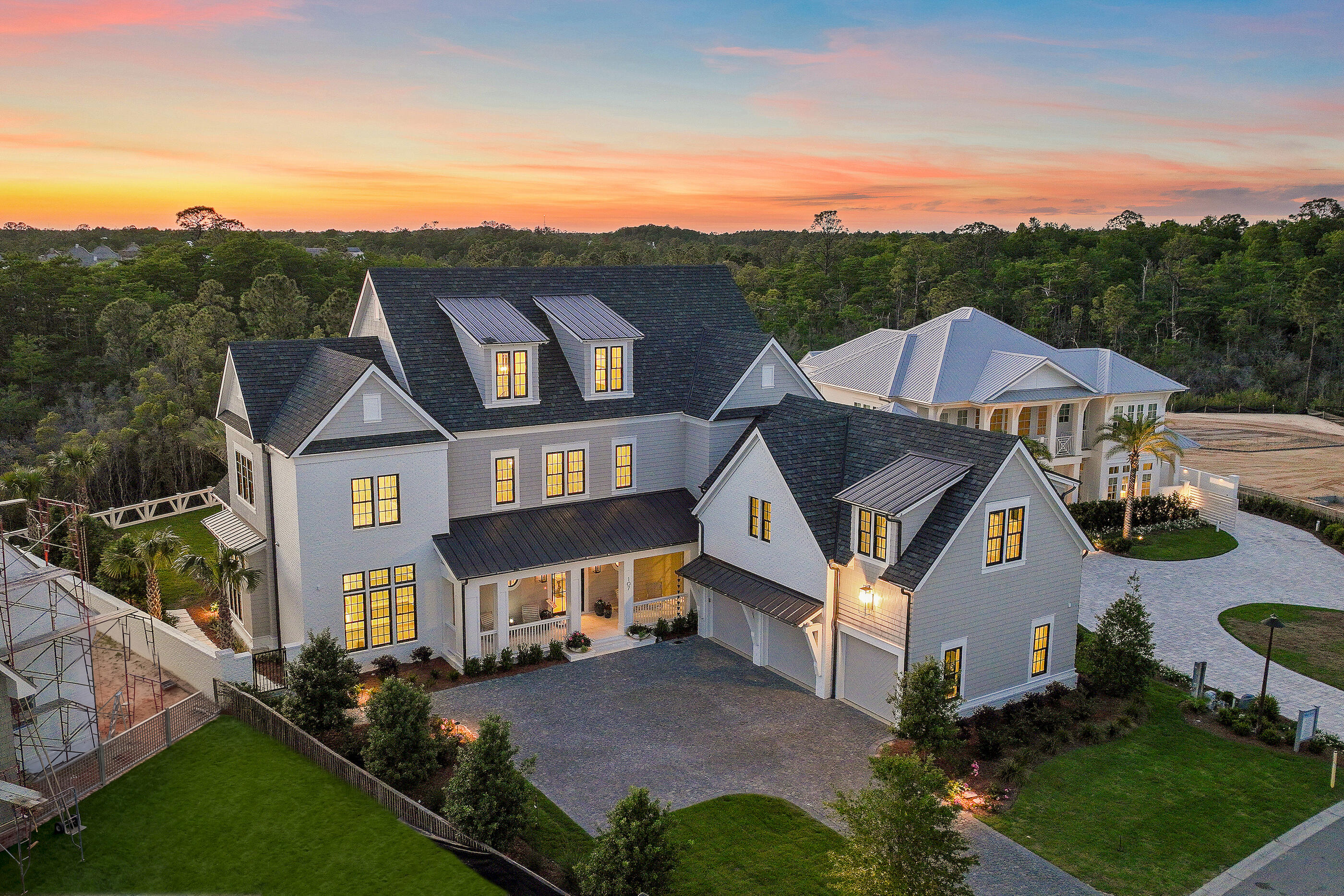 At 107 Quail Hollow Court in WaterSound Camp Creek, outdoor living takes center stage. Designed with entertaining in mind, the home's outdoor spaces extend seamlessly beyond the interior, opening to a backyard that feels both expansive and intentional. A heated saltwater pool with elegant fire bowls commands attention, offering a resort-caliber setting that invites you to slow down and stay awhile. The scale of the outdoor environment is what truly distinguishes this residence. The pool terrace gives way to a remarkably generous yard, creating a sense of openness rarely experienced in WaterSound Camp Creek. There is space to host, to play, to unwind, and to simply enjoy the luxury of having room to breathe. Whether it is a lively evening gathering or a quiet morning with coffee in hand, the setting adapts effortlessly to the rhythm of life.

A fully equipped outdoor kitchen and fireplace complete the experience, allowing days to transition naturally into evenings spent beneath the coastal sky, where every detail has been designed for comfort, connection, and elevated living. One of the defining advantages of Camp Creek living is the inclusion of a WaterSound Beach Club membership, offering access to Gulf-front amenities that further extend the lifestyle beyond the home.

Inside, the home continues to impress with a thoughtful balance of scale, comfort, and refined design. Spanning 7,950 square feet across three levels, the residence offers six bedrooms, seven full bathrooms, and three half baths, along with a three-car garage. Warm hardwood floors, coffered ceilings, and carefully considered proportions create interiors that feel expansive yet welcoming from the moment you enter.

At the heart of the home, the kitchen is designed to support both everyday living and elevated entertaining. Custom cabinetry, Sub-Zero appliances, a generous walk-in pantry, and a dedicated scullery allow the space to remain polished while accommodating gatherings of any size. Nearby, a curated wine cellar offers a refined setting for collection and display, while the adjoining living area, anchored by a fireplace and custom built-ins, provides a natural place to gather, unwind, and connect.

Upstairs, the home unfolds with spaces designed for both recreation and retreat. A dedicated game room or bunk room offers a lively setting for gathering, while the third-floor movie room with wet bar provides a more private environment for film nights, celebrations, or relaxed evenings at home.

Throughout the residence, each space has been designed with intention, balancing elegance with livability. With its generous scale, curated finishes, and exceptional indoor and outdoor living, 107 Quail Hollow Court presents a home where everyday moments feel elevated and the coastal lifestyle is experienced at its fullest.