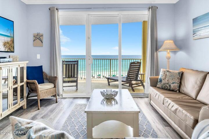 Welcome to Emerald Isle 402, where thoughtful updates, exceptional maintenance, and breathtaking Gulf views come together to create a truly turnkey beachfront retreat. Located on the desirable fourth floor, this spacious Gulf-front residence offers the convenience of a lower-floor location while still delivering stunning panoramic views of the emerald-green waters and sugar-white sands that define Panama City Beach. Designed for both personal enjoyment and strong rental performance, the open-concept floor plan comfortably accommodates up to six guests while maintaining a bright, airy feel throughout. Nine-foot ceilings, crown molding, and expansive sliding glass doors fill the living spaces with natural light and showcase the spectacular Gulf views from nearly every angle. The kitchen, dining, and living areas flow seamlessly together, creating an inviting space for gathering, entertaining, and relaxing after a day on the beach. What truly sets this residence apart is the extensive list of updates already completed. Luxury vinyl plank flooring throughout provides a clean, modern coastal aesthetic while offering exceptional durability for beachfront living. Both bathrooms feature beautifully updated custom walk-in showers, and the property has been meticulously maintained with recent improvements that include new LVP flooring (2025), washer and dryer (2024), HVAC system (2021), and water heater (2019). Offered fully furnished with high-end furnishings and accessories, the cond is truly move-in or rental ready from day one. The Gulf-front primary suite offers direct balcony access and stunning water views, creating a private sanctuary where you can wake up to the sights and sounds of the Gulf each morning. Both bedrooms feature private bathrooms, ensuring comfort and privacy for owners and guests alike. One of the home's standout features is the oversized Gulf-front balcony, measuring approximately 10' x 28'. Its distinctive curved design captures sweeping views of the coastline, providing the perfect setting for morning coffee, afternoon relaxation, or unforgettable sunsets. Accessible from both the living room and primary suite, the balcony serves as a true extension of the living space and embodies the best of coastal living. Additional conveniences include an exterior storage closet and HOA dues that cover most utilities, helping simplify ownership and property management. Emerald Isle owners and guests enjoy an outstanding collection of resort-style amenities, including indoor and outdoor pools, a whirlpool, Gulf-view fitness center, sauna, steam room, BBQ grilling area, and a poolside pavilion. Pet owners will also appreciate that owners are welcome to bring their four-legged family members. Situated on the quieter west end of Panama City Beach, Emerald Isle offers the perfect balance of tranquility and convenience. You're just minutes from Pier Park, popular dining and entertainment venues, shopping, and Northwest Florida Beaches International Airport, while still enjoying the peaceful beachfront setting that continues to make this one of the area's most sought-after destinations. Whether you're searching for a primary residence, second home, or proven investment property, Emerald Isle 402 delivers the rare combination of updated finishes, excellent condition, resort amenities, and Gulf-front living that is increasingly difficult to find. All measurements and information are deemed reliable but should be verified if important.