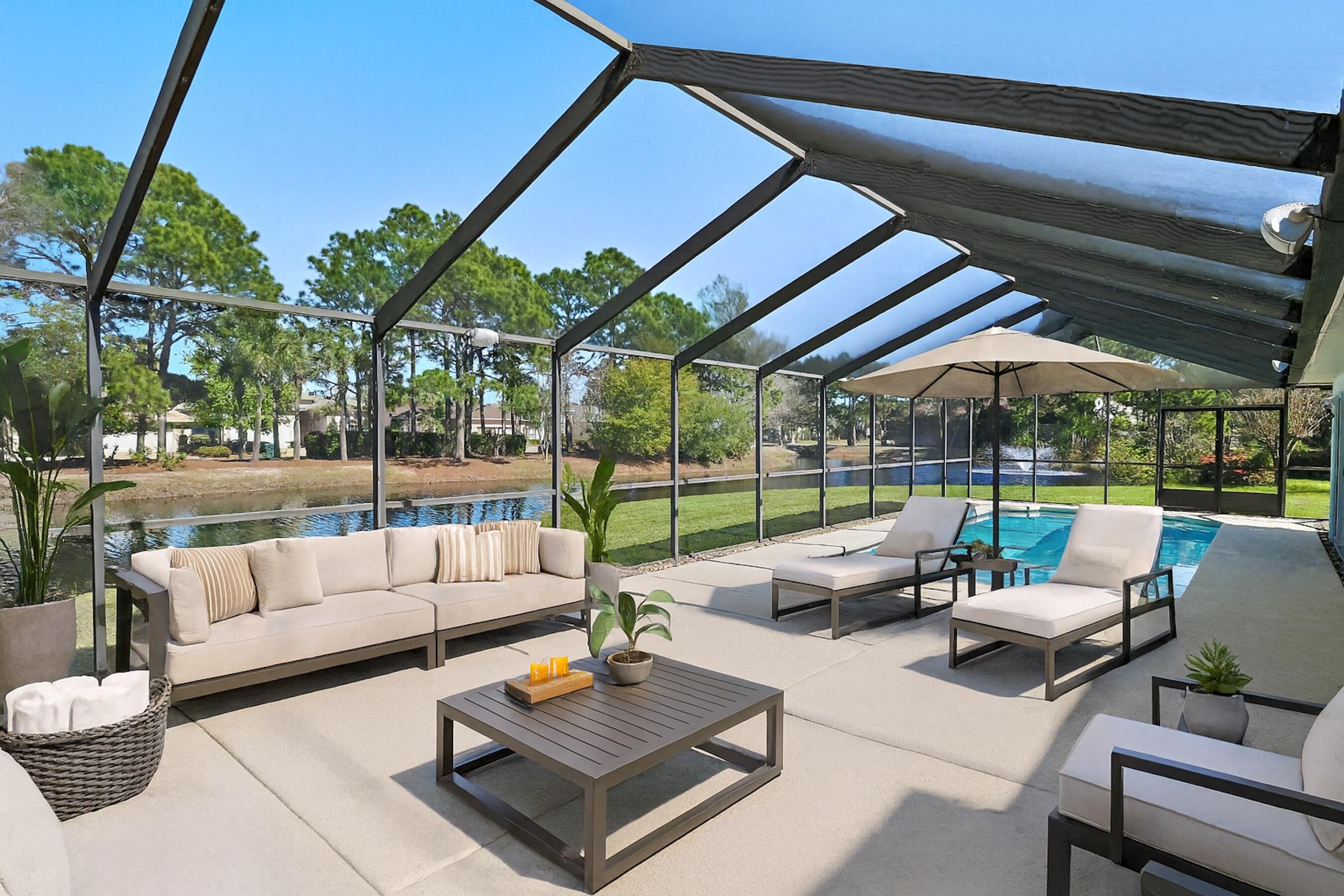 Positioned on the largest homesite in the neighborhood, this beautifully maintained lakefront residence offers an exceptional sense of space, privacy, and comfort within the gated community of Emerald Lakes. Located on a quiet cul-de-sac and spanning two lots, the property enjoys peaceful water views and an uncommon level of breathing room rarely found in this centrally located coastal setting. A thoughtful split floor plan and open living areas create an easy flow for both everyday living and entertaining, while the three-car garage with a dedicated 10-by-10 work area provides valuable storage and flexibility. Inside, the home showcases an array of modern updates and conveniences. The primary bath has been stylishly updated, complementing the home's cohesive interior design. Tile flooring runs throughout the residence, creating a clean, low-maintenance environment with no carpet. Additional improvements include an updated hot water heater, HVAC system, and new washer and dryer. The interior and garage have also been freshly painted, and the garage features durable epoxy flooring for a polished finish. Outdoor living is a defining feature of this property. A remarkable 25-by-60 screened lanai stretches along the lakeside of the home, creating an expansive covered retreat for relaxing or hosting gatherings. Recently rescreened with new doors, the space includes an outdoor television, audio system, and speakers for effortless entertaining. The private pool and surrounding deck have been resurfaced, providing a refreshed setting for warm Florida afternoons. A fenced side yard offers additional space for pets or recreation, while the portable generator connection with a manual transfer switch adds an extra layer of preparedness and convenience. Practical upgrades continue with a roof replacement and a system maintained termite bond. The home is also the only property in the neighborhood featuring a three-car garage, making it a rare opportunity within this established community. Emerald Lakes offers a gated environment with low HOA fees and a range of amenities designed for an active coastal lifestyle. Residents enjoy a community pool, park, tennis and pickleball courts, along with the convenience of a traffic light at Highway 98 for easy access. The location places the home within biking distance of the beach and just minutes from Destin Commons, Sandestin, and Destin Harbor, providing quick access to shopping, dining, entertainment, and the sugar-white sand that defines the Emerald Coast.
