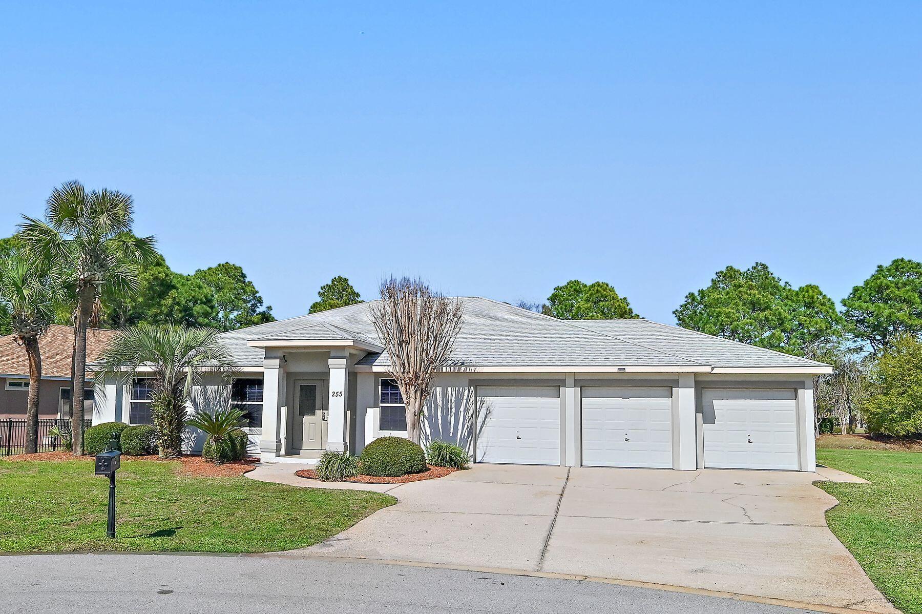 Property is under contract with a 72-hour kick-out clause. Positioned on the largest homesite in the neighborhood, this beautifully maintained lakefront residence offers an exceptional sense of space, privacy, and comfort within the gated community of Emerald Lakes. Located on a quiet cul-de-sac and spanning two lots, the property enjoys peaceful water views and an uncommon level of breathing room rarely found in this centrally located coastal setting. A thoughtful split floor plan and open living areas create an easy flow for both everyday living and entertaining, while the three-car garage with a dedicated 10-by-10 work area provides valuable storage and flexibility. Inside, the home showcases an array of modern updates and conveniences.  The primary bath has been stylishly updated, complementing the home's cohesive interior design. Tile flooring runs throughout the residence, creating a clean, low-maintenance environment with no carpet. Additional improvements include an updated hot water heater, HVAC system, and new washer and dryer. The interior and garage have also been freshly painted, and the garage features durable epoxy flooring for a polished finish. Outdoor living is a defining feature of this property. A remarkable 25-by-60 screened lanai stretches along the lakeside of the home, creating an expansive covered retreat for relaxing or hosting gatherings. Recently rescreened with new doors, the space includes an outdoor television, audio system, and speakers for effortless entertaining. The private pool and surrounding deck have been resurfaced, providing a refreshed setting for warm Florida afternoons. A fenced side yard offers additional space for pets or recreation, while the portable generator connection with a manual transfer switch adds an extra layer of preparedness and convenience. Practical upgrades continue with a roof replacement and a system maintained termite bond. The home is also the only property in the neighborhood featuring a three-car garage, making it a rare opportunity within this established community. Emerald Lakes offers a gated environment with low HOA fees and a range of amenities designed for an active coastal lifestyle. Residents enjoy a community pool, park, tennis and pickleball courts, along with the convenience of a traffic light at Highway 98 for easy access. The location places the home within biking distance of the beach and just minutes from Destin Commons, Sandestin, and Destin Harbor, providing quick access to shopping, dining, entertainment, and the sugar-white sand that defines the Emerald Coast.