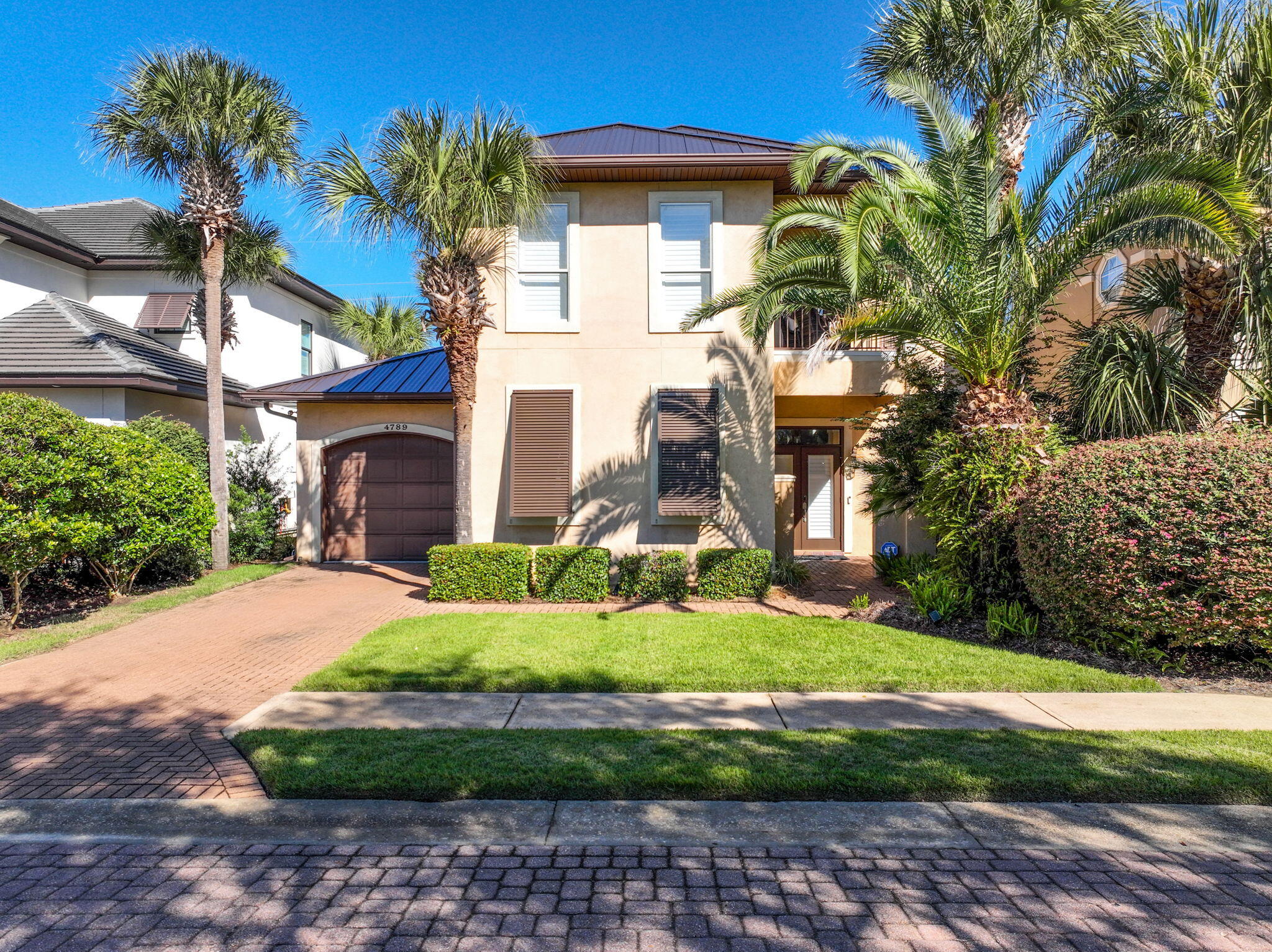 ROOM FOR A POOL!- HOA has previously approved.  Welcome to refined coastal living in the gated community of Destiny East. Ideally positioned just steps (approximately 150 yards) from neighborhood's premier amenities, this beautifully maintained home offers easy access to one of the community pools, the clubhouse, fitness center, and more all while maintaining a sense of privacy and retreat. 
From the moment you arrive, the curb appeal makes an impression. Lush, established landscaping and mature trees frame the property, while the newly installed standing seam metal roof (2025) adds both durability and architectural appeal. Inside, a semi-private foyer opens to a light-filled living space where double French doors and shadow box windows invite in an abundance of natural light. Coastal details shine throughout, including a charming shiplap accent wall that anchors the living room with warmth and style. 
The kitchen is designed for both everyday living and entertaining, featuring granite countertops, a generous breakfast bar, ample cabinetry, and stainless-steel appliances. The open concept layout seamlessly connects the kitchen, dining, and living areas creating an inviting space where everyone can gather comfortably. The first floor also offers a guest bedroom with convenient access to a shared bath, ideal for visitors. 
Upstairs, a covered balcony creates a peaceful escape and is accessible from both the landing and the primary suite, perfect for enjoying morning coffee or evening breezes. Both upstairs guest bedrooms have been updated with tile flooring for a clean, coastal look. The primary bathroom has been thoughtfully renovated, showcasing a spacious walk-in shower with bench seat and distinctive brick detailing. The second guest suite enjoys its own private bath, also remodeled with updated fixtures and finishes. 
Back downstairs, the outdoor living space truly expands your options. A covered porch with grilling area flows to an expansive paver patio with direct access to the greenway that leads to the community amenities. The generous lot offers plentiful space to add a private pool if desired.  In fact, the HOA has previously approved pool plans for this property.  The home is offered unfurnished however select furnishings may be available for negotiation.
Destiny East residents and guests enjoy an exceptional amenity package including the peace of gated access from both Scenic 98 and US Hwy 98, two community pools (one at the clubhouse and one along Scenic Highway 98 overlooking the lake), a hot tub, playground, fitness center, theater room, tennis courts, and a beautifully appointed clubhouse ideal for hosting gatherings. Located on the east end of Destin, the community provides easy access to dining, shopping, and entertainment with golf cart convenience to nearby restaurants and the beach. Within five miles you'll find Destin Commons, The Crab Trap, Silver Sands Premium Outlets, Seascape, and countless other local favorites.