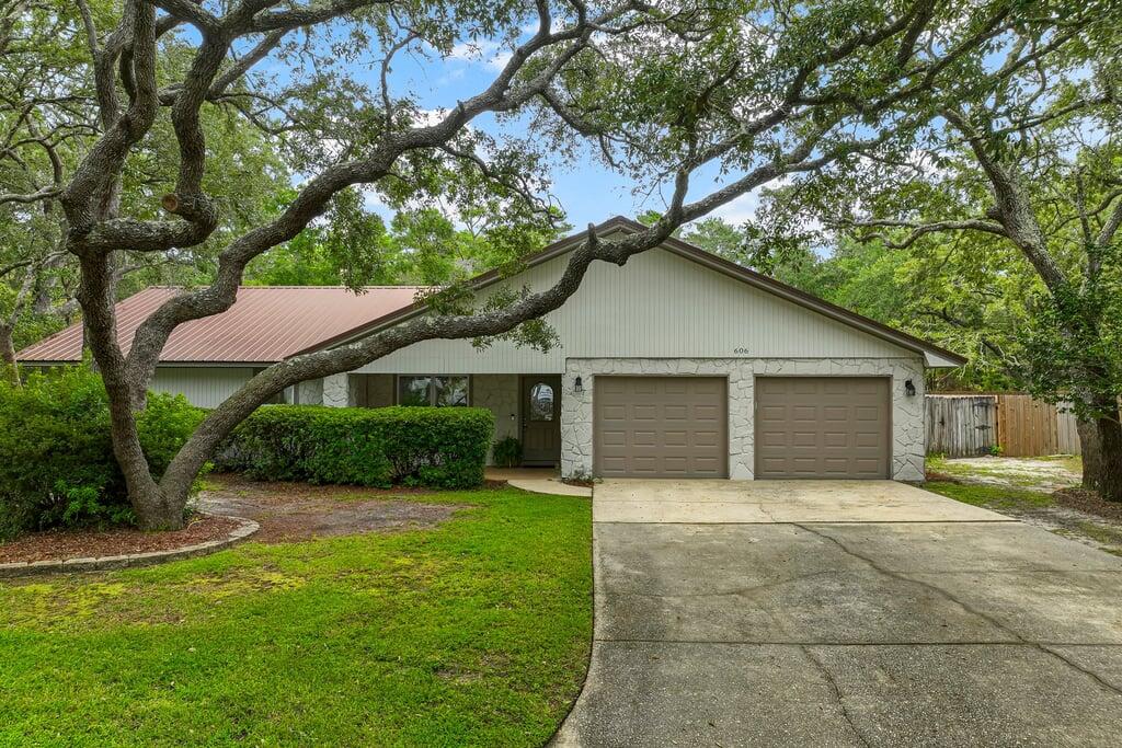 Welcome to this beautifully updated 4-bedroom, 2-bath home with a 2-car garage, ideally located in the highly desirable Bluewater Bay community and in a highly sought-after price range.

Inside, you'll find a thoughtful blend of style and comfort, featuring durable LVP flooring in the main living areas, cozy carpet in the bedrooms, brushed nickel fixtures, granite countertops, and stainless steel appliances. The spacious great room centers around a charming wood-burning fireplace and flows seamlessly into a bright Florida room--creating the perfect setup for both everyday living and entertaining. Step outside to a large, fenced backyard with plenty of room to relax, play, or host gatherings--all while enjoying the added bonus of backing up to a reservation area - extra space and serenity.

Beyond the home, the lifestyle truly shines. The Woodlands offers sidewalks, walking paths, and a park, along with access to the Woodlands Pool--a 25-meter, 5-lane pool open daily for members. Plus, you're zoned for highly regarded schools and just minutes from the Mid-Bay Bridge, making trips to Destin's beaches, dining, and entertainment quick and easy.

This home checks all the boxes--location, lifestyle, and value--in one of Niceville's most beloved communities.