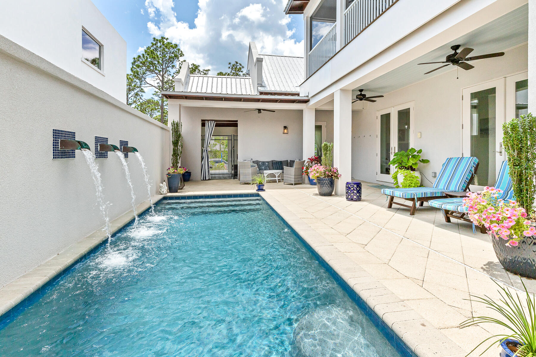 Alys Beach inspired concrete home in the heart of Seagrove. This 4 bedroom home is located just off 30A in Gulf Shore Manor that boasts deeded beach access and use. The moment you pass through the portico, the home unfolds into a sanctuary designed for seamless indoor-outdoor living. The central hub is anchored by natural light filled great room, where 18-foot cathedral ceilings are accented by local cypress beams. Three sets of oversized doors disappear to invite the coastal breeze inside. This beach home was created to enjoy a fluid connection to the private courtyard and heated saltwater pool. 

The chef's kitchen is fully equipped with dual dishwashers, double sinks, a new gas range, and a expansive island that serves as the natural gathering spot. The primary suite, located on the main level, feels like a boutique resort wing. It features expansive dual walk-in closets, a spa-like shower with double heads, and direct pool access, allowing you to wake up to views of the water feature every morning. A second bedroom is located on main floor with easy access to outdoor living area. 

The private oasis includes a tranquil water feature and a tucked-away summer kitchen--complete with a grill, refrigerator, and sink--perfect for poolside dining. Upstairs, a large screened porch overlooking a view of the pool sanctuary, providing a peaceful escape for morning coffee or evening cocktails. With two additional oversized bedrooms featuring built-in bunks, the home is thoughtfully scaled to accommodate guests with ease.

Located on a low-density street with a 15 foot buffer on one side, this property offers a sense of seclusion while being moments from the energy of Seaside (1.3 mile to the west) and WaterColor (less than 2 miles). Owners and guests enjoy over 1,400 feet of deeded beach access at the end of the street, making it easy to transition from the pool to the emerald waters of the Gulf. Offered fully furnished and including a street-legal LSV, this turnkey property is an exceptional opportunity for full time residence,  a second home, high-performing investment with established bookings already in place. Also within a short distance is regional beach access with seasonal lifeguards, ramp to the beach, restrooms and plenty of parking. Other walkable neighborhood beach access include Dothan, San Juan, Montigo and Pelayo offering plenty of options to enjoy the white sandy beaches of 30A.