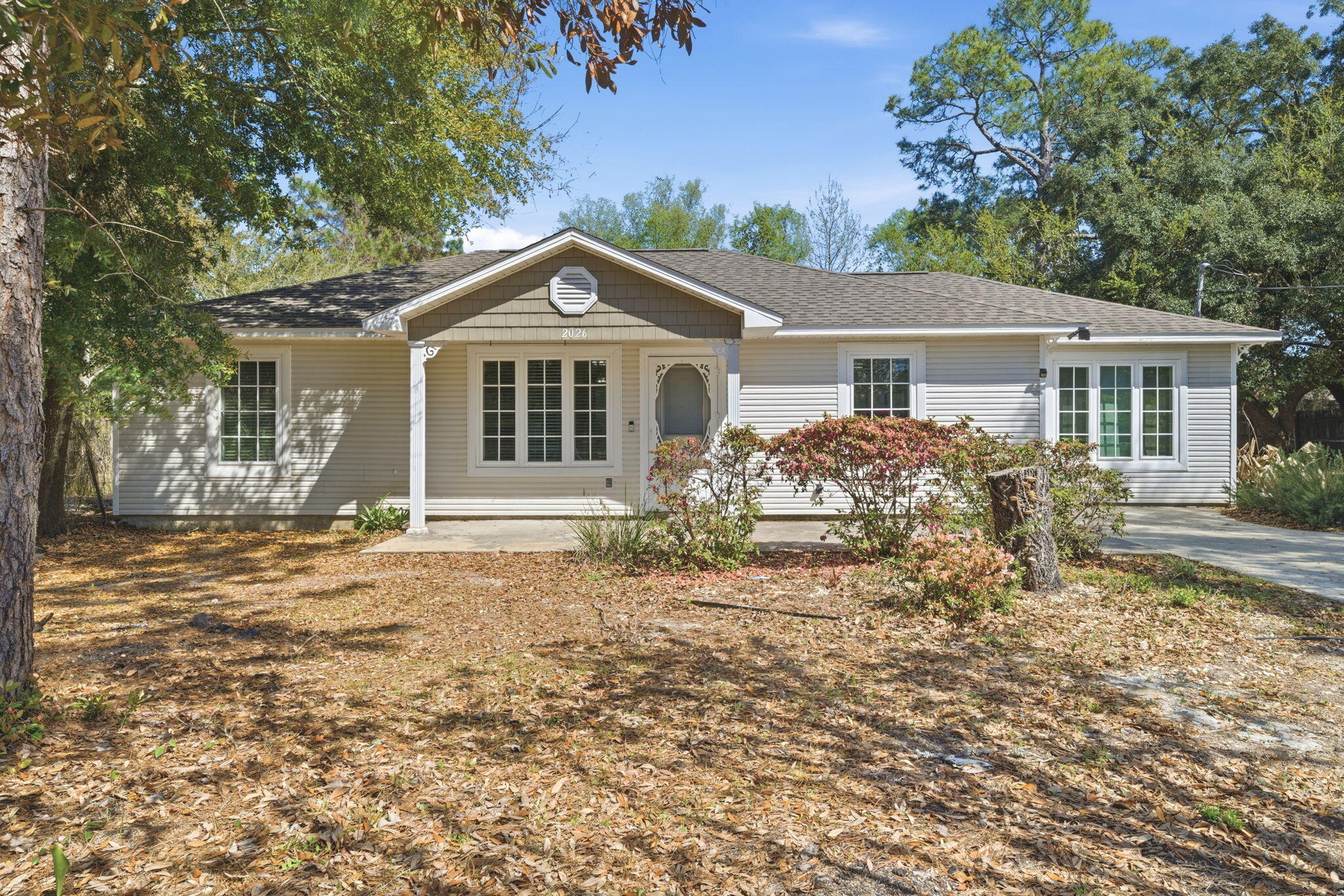 Welcome to this charming 3 bedroom, 2 bathroom Florida Cottage style home - nestled on a generous sized 0.5 acre lot in Midway in Gulf Breeze. Great location to Navarre and Pensacola beaches - with no HOA! Making this a great option as a primary residence or rental investment! Inside, the split floor plan maximizes functionality and privacy - with the kitchen and dining area at the center of the home, and natural light filling the space through the slider doors to the backyard. Additionally, this property offers a 2025 roof, an indoor laundry   room, all tile and wood plank flooring, and a versatile, separate living space - great for a private home office, playroom, or den. The backyard patio features an extended concrete patio and an expansive yard that's ready for you to turn into the ultimate outdoor entertaining space - with included powered open horse barns! Schedule your showing today!