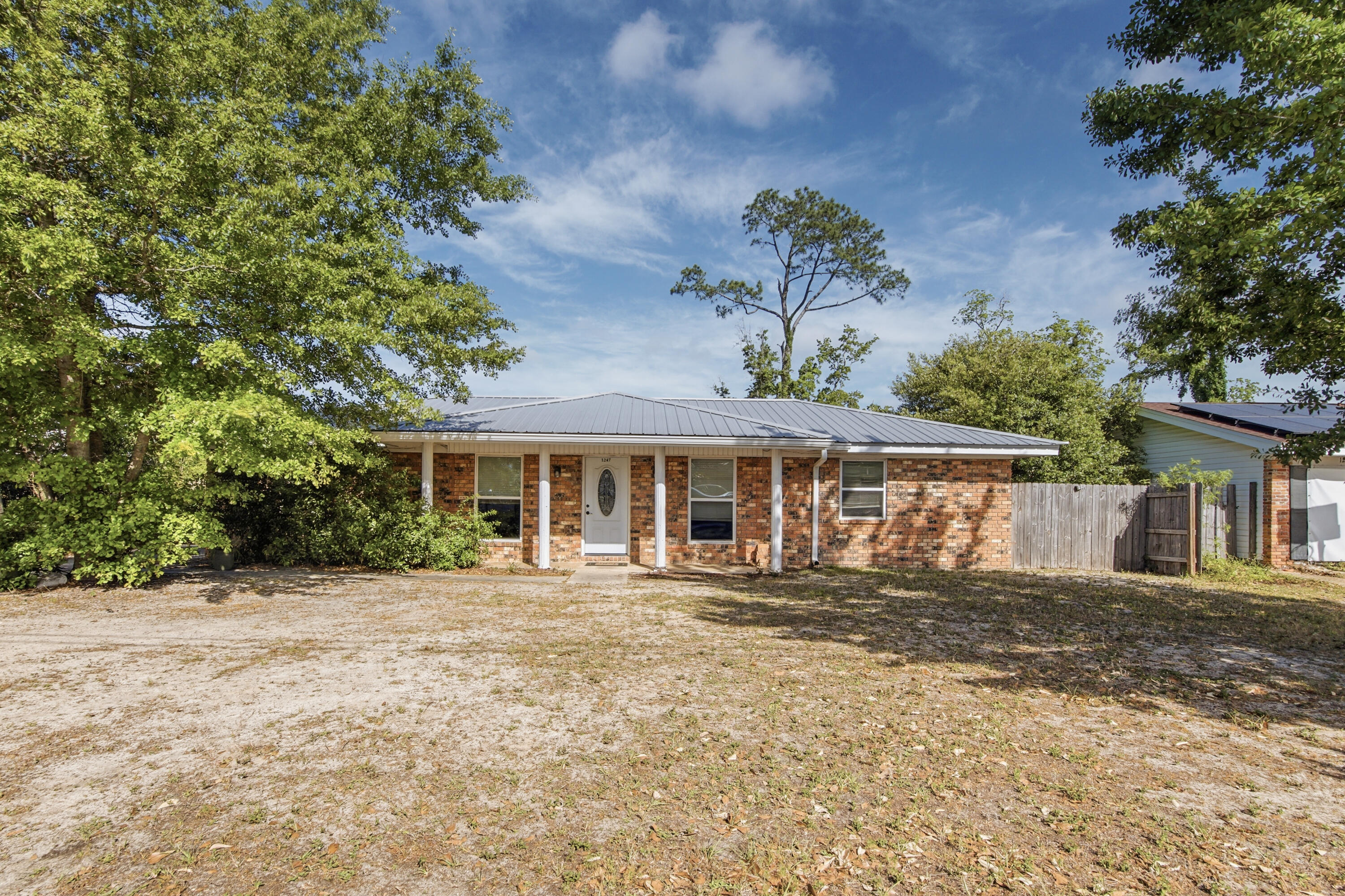 Welcome to this charming single-level ranch-style brick home located in the desirable Oxford Place area! Offering 3 bedrooms, 2 bathrooms, and 1,375 square feet of comfortable living space, this well-maintained home sits on a generous .275-acre lot and does not require flood insurance--a valuable benefit for peace of mind and savings.Inside, you'll find a functional open layout with updated tile flooring throughout the living, dining, and kitchen areas, creating a clean and modern feel. The bedrooms feature newer carpet for added comfort, and updated windows allow for plenty of natural light while improving energy efficiency. Step outside to enjoy the spacious, fully fenced backyard--flat and ideal for entertaining, pets, or future additions.  A convenient storage shed provides extra space for tools, lawn equipment, or hobbies. Major system updates have already been taken care of, including a metal roof (2018), HVAC system (2022), and water heater (2020), offering added value and peace of mind for the next owner. Whether you're a first-time buyer, downsizing, or looking for a solid investment, this move-in-ready home combines comfort, updates, and a great location. Don't miss your opportunity to make it yours!