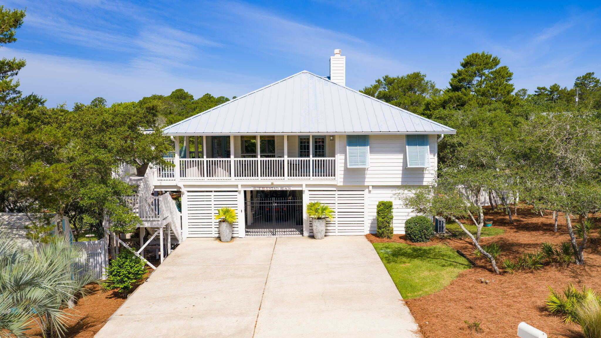 Known as one of the best lots in Blue Mountain Beach, this interior designer's personally curated coastal bungalow sits just moments from the area's world-famous sugar-white sands and emerald waters.
Exuding timeless charm and authentic Old Florida character, the home offers the perfect blend of coastal elegance and relaxed living. Upstairs features three bedrooms and two baths, while the downstairs includes a completely separate studio apartment.
A fully fenced yard, spectacular pool, and expansive grounds complete this rare offering. With no neighbors on one side and no VRBOs on the other, the property delivers exceptional privacy and peaceful tranquility -- ideal for full-time residents. At the same time, the separate studio apartment provides excellent income potential or space for family and guests.