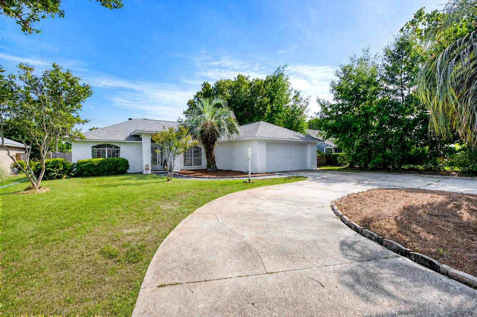 Welcome to this updated all-brick home in the desirable Tiger Point area! Zoned for the highly rated Gulf Breeze school system and offering the freedom of no HOA, it's conveniently located near Tiger Point Golf Club, grocery stores, restaurants, and just 2 miles from the Oriole Beach Boat Ramp. This home combines a prime location with numerous recent updates (list in MLS docs), including a 2025 HVAC system, 2021 roof, and 2021 water heater. The modern white brick exterior is complemented by a circular driveway, large two-car garage, and additional parking space for a boat, RV, or camper. Inside, the home is being used as a 4 bedroom. You'll find all tile and LVP flooring with no carpet, along with two flexible living spaces, a bonus room that can serve as an office, dining room, or additional bedroom (current use), plus a Florida room that expands the living area! The spacious living room features a cathedral ceiling, skylight, granite-framed fireplace, and abundant natural light. The kitchen is modern and equipped with white cabinetry and all lower cabinets have pull out drawers, granite countertops, stainless steel appliances, a large island, pantry, and a sunny breakfast nook. The split floor plan offers privacy, with the primary suite featuring an ensuite bath complete with a granite double vanity, a walk-in closet, a garden tub, and tiled walk-in shower. Two additional bedrooms and a guest bathroom are situated on the opposite side of the home. The fully fenced backyard includes a patio for relaxing and a 10x16 aluminum storage shed for added storage. Move-in ready and packed with updates, this Tiger Point home offers flexible living spaces, room for boat or RV parking, and an unbeatable location close to everything Gulf Breeze has to offer!