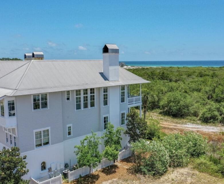 A truly exceptional home with views of the Gulf of America offered for a long-term rental lease. This fully furnished beach home with a private elevator, and beautifully decorated french-inspired furnishings has been featured in coastal magazines. Upon entering on the first level, you'll find a custom built-in queen sized bunk room with a large bathroom, farmhouse sink, and huge shower. As well as a laundry room, owners closet, patio and 2 car garage. As you take the private elevator or stairs to the second floor, you will find 3 generous sized bedrooms with ensuite baths, including the primary suite, and a quaint office nook. Through the windows of the 2 guest bedrooms, you'll see the lily pads on Cypress Pond. The primary suite is a romantic setting with gorgeous views of Topsail Reserve