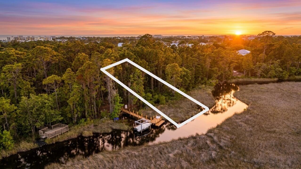 A dream come true for the discerning buyer awaits with this estate-sized, lakefront lot in Inlet Beach! Located on the headwaters of scenic and tranquil Lake Powell, you can take a leisurely boat or kayak ride all the way to the Gulf and the secluded beaches of Camp Helen State Park. At just over a half-acre, this spacious lot accommodates a sizable home nestled among native coastal scrub and pines along the shoreline. With neighboring homes ranging from 4,000 to 6,000 square feet, this is the perfect canvas for your dream estate. The North Inlet Beach location is exceptional, sitting just a mile or two from the iconic eastern 30A communities of Rosemary Beach and Alys Beach. A short bike or LSV ride brings you to the Inlet Beach Regional Beach Access, featuring over 17 acres of beachfront, ample parking, restrooms, and seasonal lifeguards. 30Avenue, an upscale shopping and dining venue is just a few blocks away. This is truly one of the most remarkable locations for full-time luxury living!
