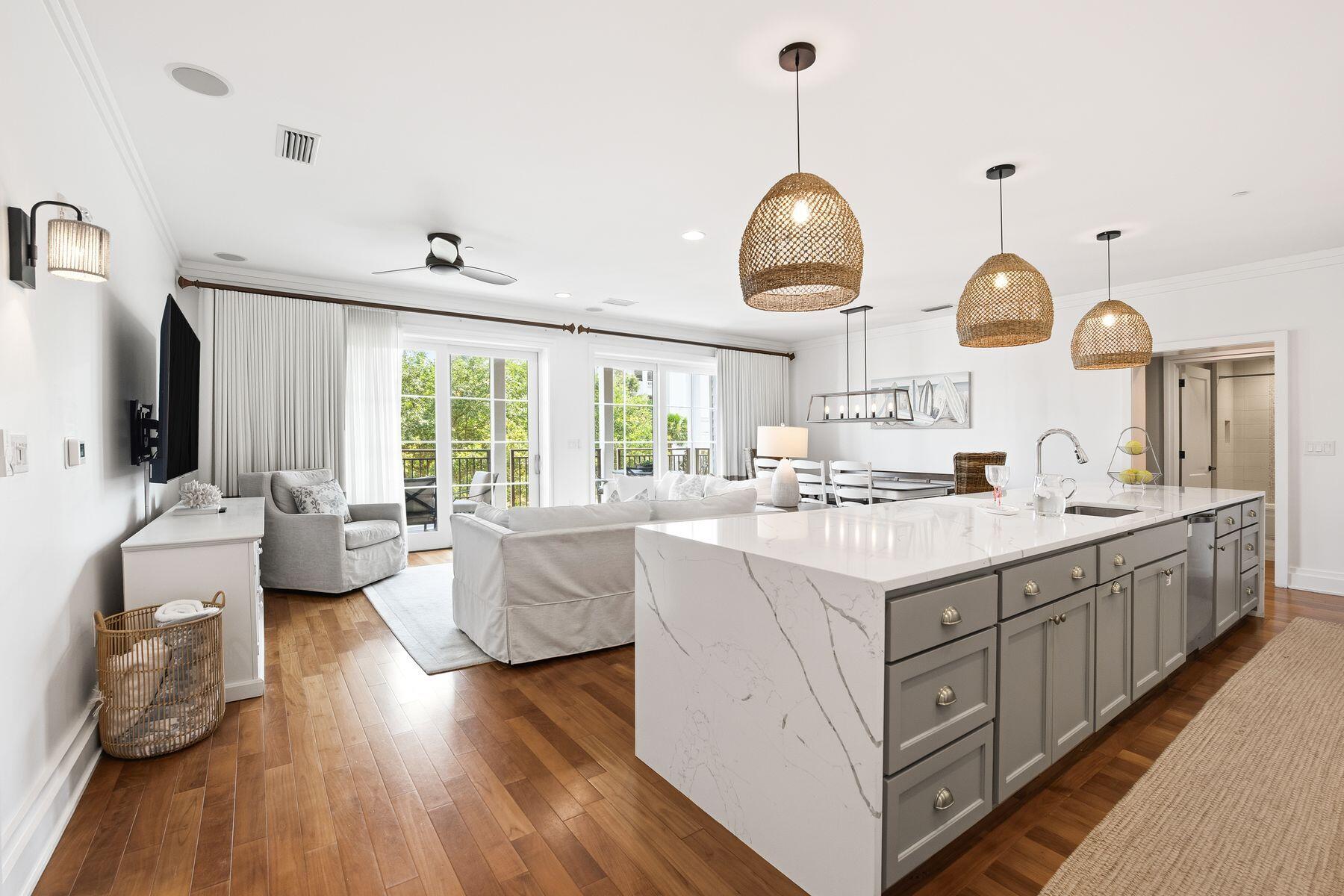 Positioned along Scenic Highway 30A just across from deeded beach access, this beautifully appointed residence offers an exceptional opportunity to enjoy the coastal lifestyle in one of the area's most exclusive low-density condominium communities. With only 17 residences, this boutique retreat combines outstanding privacy, refined finishes and resort-inspired amenities, all within moments of the area's renowned dining, shopping and beaches.

Designed for effortless living and entertaining, the spacious open-concept floor plan flows seamlessly from the kitchen into the dining and living areas, before extending onto an expansive covered balcony.

The thoughtfully designed kitchen serves as the centerpiece of the home, featuring a striking waterfall-edge quartz island, custom vent hood, premium appliances and abundant workspace. Hardwood flooring carries throughout the main living areas, while three generously sized bedrooms and three full bathrooms comfortably accommodate family and guests. A custom-built bunk room adds flexibility for additional sleeping arrangements and the full-size laundry room with extra storage enhances everyday convenience. An additional private owner storage unit is also included. The community's recently completed exterior restoration, along with updated fitness facilities and pool amenities, provides peace of mind and a fresh, contemporary appearance. Residents enjoy access to an impressive rooftop terrace featuring a heated pool, bubbling spa, grilling stations and panoramic Gulf views, creating an exceptional setting for relaxing or entertaining. Additional amenities include a state-of-the-art fitness center with a steam room and sauna, an elegant owners' lounge with a catering kitchen, elevator access, and the convenience of WaterHouse Provisions & Bottle Shop located on the ground floor.

Sold fully furnished and currently operating as a successful vacation rental with future bookings already in place, this turnkey residence presents an outstanding opportunity as a primary home, second residence or investment property in one of 30A's most desirable locations.