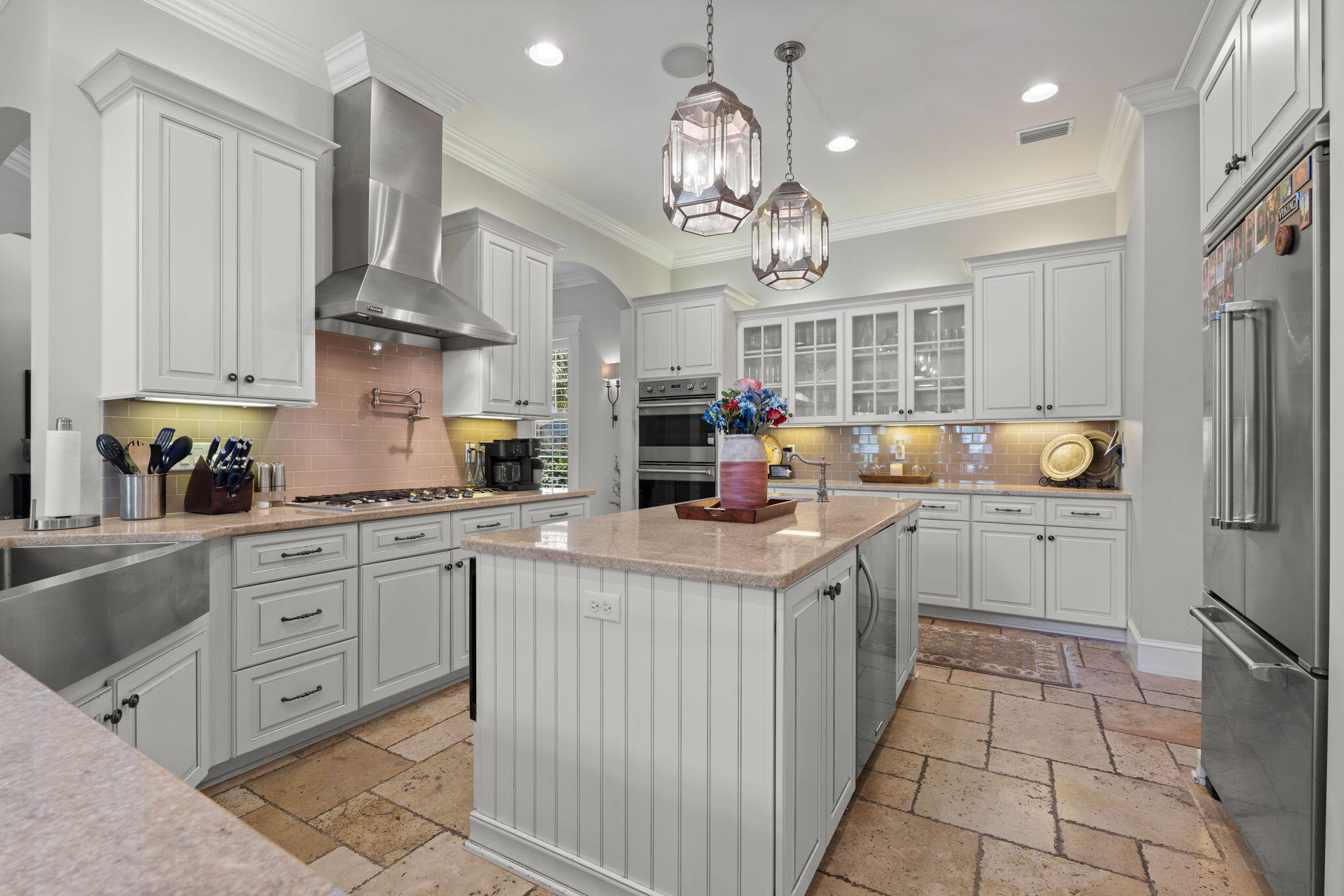 See Additional Remarks--- Experience refined coastal luxury at 4319 Sunset Beach Circle, a custom-built residence in the exclusive guard-gated community of Sunset Beach within Bluewater Bay. Offering 3,107 square feet of thoughtfully designed living space, this exceptional home blends elevated design, superior craftsmanship, and energy-efficient construction into one impressive package.

A pavered drive and Versailles-pattern travertine walk lead to a covered entry accented with tongue-and-groove wood ceilings and grand mahogany double doors with aged bronze hardware. Inside, natural light pours into the expansive main level where soaring ceilings and seamless travertine flooring connect the formal dining area, great room, chef's kitchen, and breakfast nook. The scale is both dramatic and welcoming, perfectly suited for intimate evenings or larger gatherings.

Extensive millwork, custom casings, and curated finishes elevate every space. The great room showcases 22-foot ceilings, statement chandeliers, a gas fireplace, and custom built-ins, all flowing effortlessly into a designer kitchen outfitted with professional-grade stainless steel Viking appliances, including dual convection ovens, a five-burner gas range with pot filler, and a Viking refrigerator. An oversized island with prep sink and beverage station anchors the space, while soft-close cabinetry and a generous walk-in pantry provide abundant storage without sacrificing style.

The primary suite is privately situated on the main floor behind double eight-foot doors, offering a serene retreat with a spa-inspired bath featuring dual vanities with Carrara marble tops, a soaking tub, walk-in shower with dual heads, private water closet, and spacious walk-in closet.

Outdoor living is equally impressive. French doors and sliding glass panels open to a large covered porch complete with tile flooring, wood-paneled ceilings, and ample space for lounging or dining. Pre-plumbed for gas, water, and electric, the area is ready for a future summer kitchen. Beyond, mature landscaping and a generous sodded lawn create a beautiful and functional backyard setting.

Upstairs, two oversized bedrooms each enjoy private en suite baths, while a fourth bedroom--currently used as an office--offers flexibility along with a finished, climate-controlled walk-in storage space.

Built with 2x6 construction, spray fiber insulation, and foam roof decking, the home is designed for efficiency and durability. A DECRA stone-coated steel roof with, NEW Rinnai tankless water heater, dual Lennox heat pumps, Manabloc plumbing system, surround sound, and Kevlar hurricane shutters further highlight the home's commitment to quality and performance.

Residents of Sunset Beach enjoy exclusive access to Niceville's only bayfront, resort-style pool, private sandy beach, clubhouse, and 24-hour manned security, with HOA dues that include lawn maintenance and lawn irrigation.

A custom home of this caliber, in this location, is a rare offering--thoughtfully designed, impeccably finished, and positioned within one of Niceville's most desirable waterfront communities.