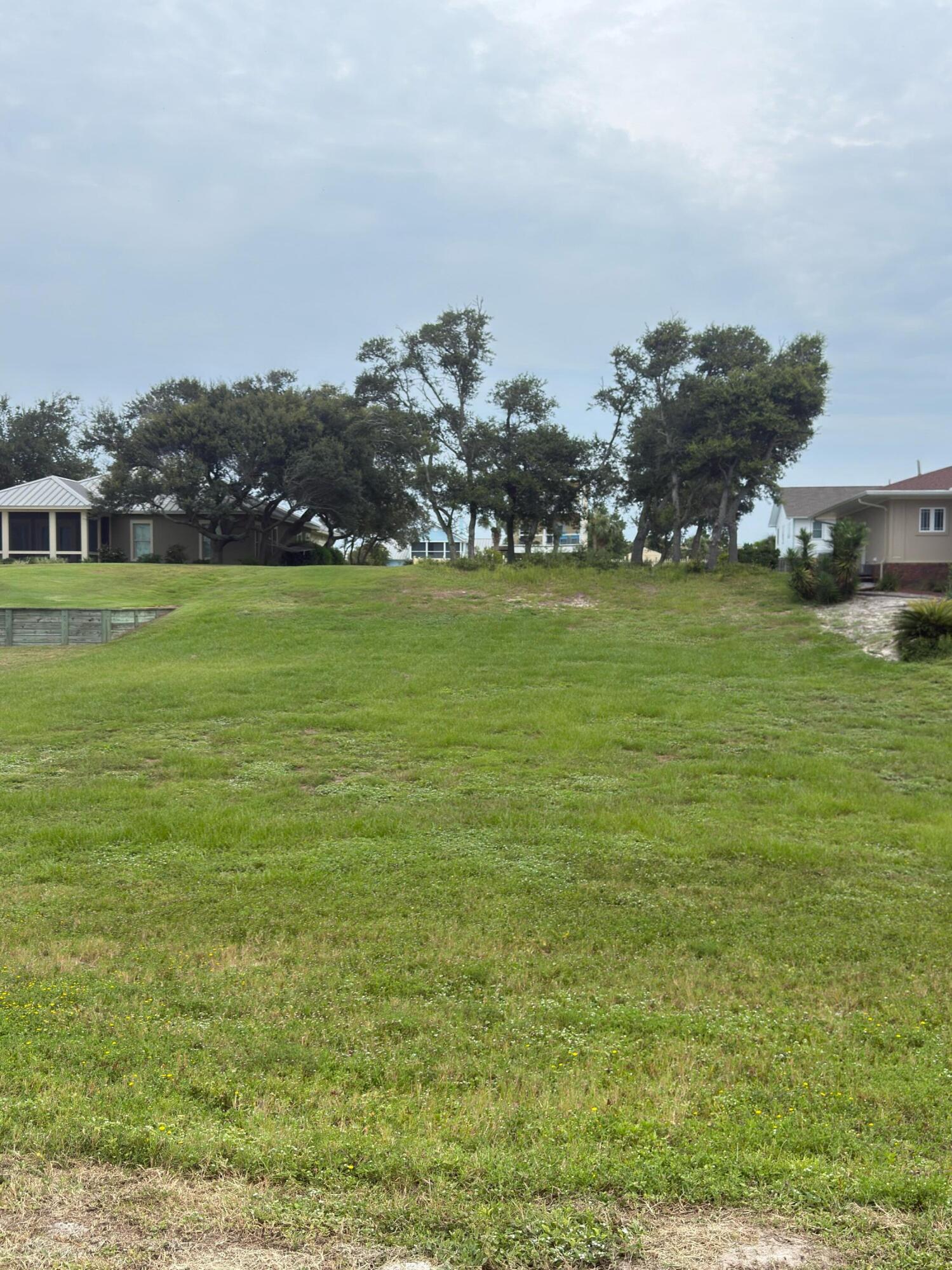 Beautiful elevated Gulf View Building lot located in Beacon Hill. This is not one of the postage stamp lots crammed on Highway 98, Rather, one of the last large gulf view lots that is 75' x 250' and .43 acres MOL as well as located in the X FLOOD ZONE. Enjoy elevated yet ground floor living options which is very rare at the beach. Very close to Lightkeeper's county park that has walking trails, amphitheater, pickle ball courts, dog park, picnic facilities, boardwalk for Gulf of America. Bring your plans and get ready to enjoy gorgeous sunsets. Some dimensions were obtained from the Gulf County Property Appraiser's website, please verify if important. Please do not use the neighbor's driveway for access as this is not part of the property