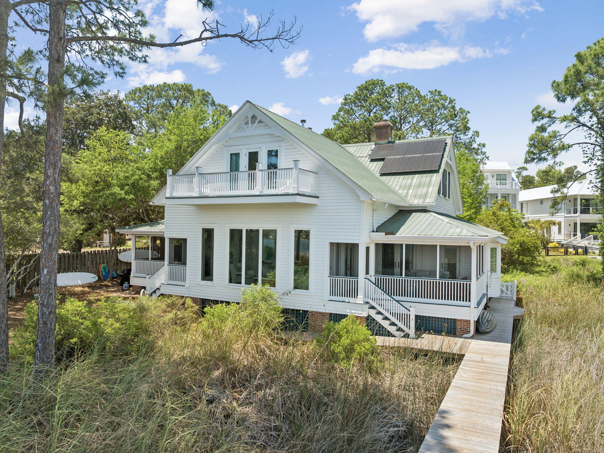 This is one of those settings that simply cannot be recreated. Positioned directly on Eastern Lake, one of Florida's rare and protected coastal dune lakes, this 4BR/4BA property offers a lifestyle that's virtually impossible to find on the market today: private waterfront, a private dock for kayaking straight to the beach, an oversized homesite, and true walkability to the sand. A private setting yet so close to the beach, shopping and dining.

 The home itself is full of character that is unique to our area. Thoughtfully renovated to blend modern comfort with timeless coastal architecture, it features 13-foot ceilings, heart-of-pine floors, multiple fireplaces, and mature landscaping that gives the whole property a settled, established feel new construction can't replicate. With 4 bedrooms, 4 bathrooms, and two primary suites (one on the main level, one upstairs), plus nearly 3,000 square feet of living space, the layout offers flexibility for multi-generational living, guests, or a second-home retreat. Multiple porches and decks extend the living space outdoors, framing nonstop views of Eastern Lake from nearly every angle.
Whether as a primary residence, second home, or investment, this is a once-in-a-generation opportunity to own an irreplaceable setting: private lake frontage, dock access, walk-to-beach convenience, and room to expand -- all in one of 30A's most sought-after communities. Minutes to the beach or ride your golf cart to Seaside. This home can easily reach the beach from its dock or walking on the street. Very private setting and yet close to the beach and shopping and restaurants.