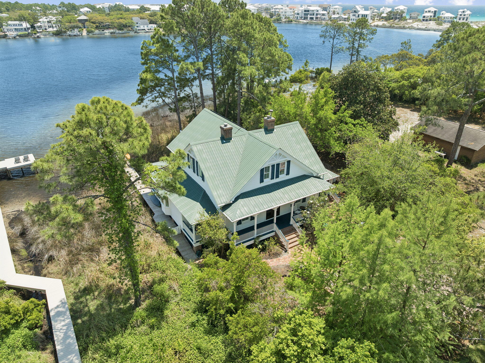 Experience the best of coastal living in this beautifully updated 4 bedroom home, ideally situated on a rare coastal dune lake in Seagrove. It has nonstop VIEWS of EASTERN LAKE with surrounding privacy and an oversized lot.  
*Kayak or paddle to the beach from your private dock. 
Thoughtfully renovated blends modern upgrades with relaxed coastal charm and move in ready! 
The home has 4 BR / 4BA with a master on the main and second level. Lots of outdoor living with porches and decks to enjoy the water views from.
This amazing home has 2971 sq ft of living space, 13 ft ceilings, heart of pine floors, multiple fireplaces. *
*A short walk to the beach
ideal as a primary residence,second home, or investment opportunity. There is a an extra lot next to it that is also for sale that you could build a carriage home on with pool or another home entirely. It can be purchased as part of the sale. The other lot faces South Gulf Drive and could have it's own separate driveway.