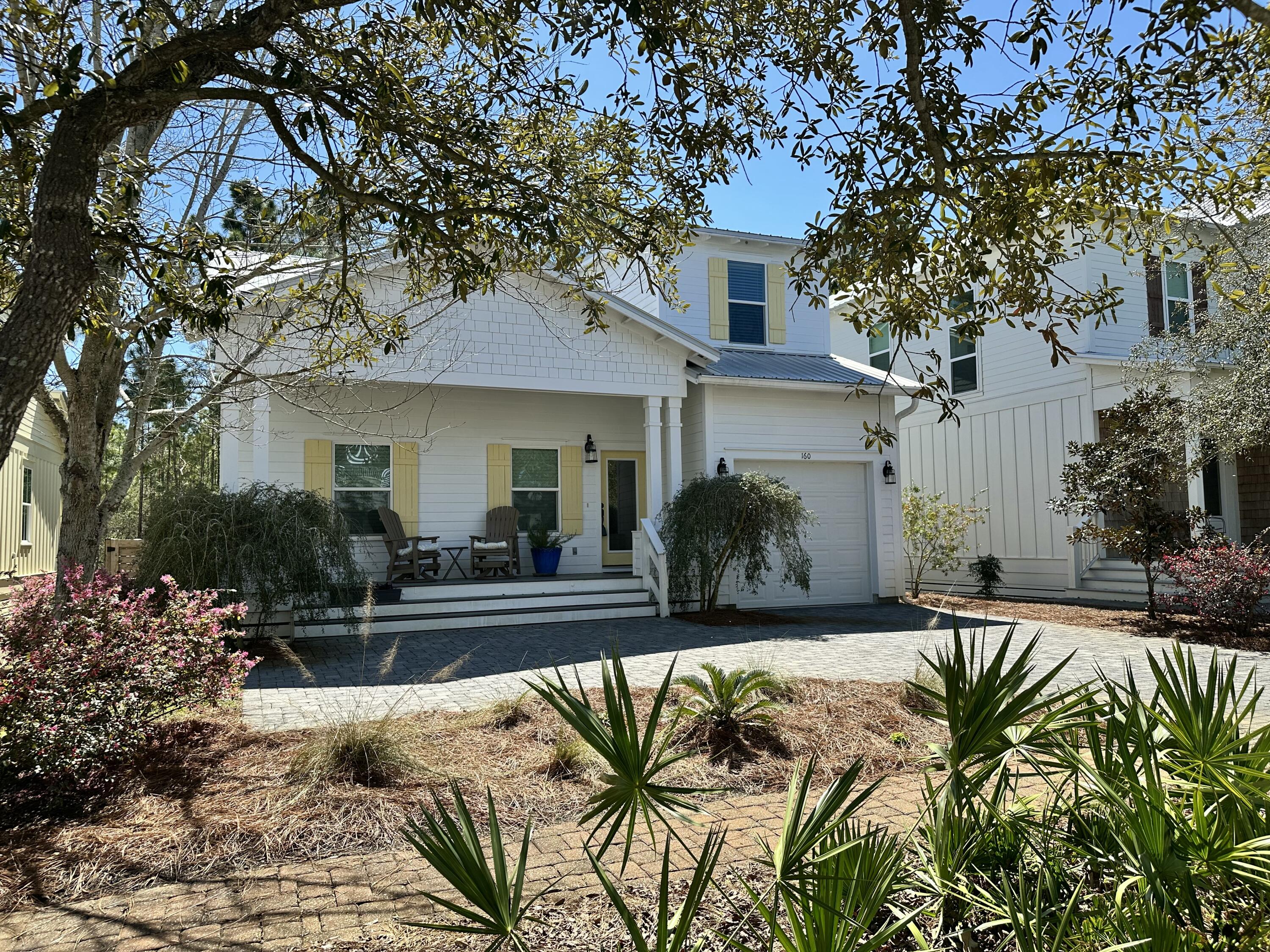 Tucked away in the gated community of Hidden Grove, this coastal cottage backs up to a state nature preserve.  An expansive deck along the entire rear of the home, provides a wonderfully private venue to enjoy the outdoors. The home is appointed with granite counter tops throughout, hardwood floors in the living, dining, and kitchen areas as well as the downstairs master bedroom.  Upstairs, the three bedrooms and loft area are carpeted.  Master bath and other two bathrooms have tile flooring.  The downstairs master has two closets, and the adjoining bathroom has two vanities, a garden tub, and separate shower. The spacious living space has extreme vaulted ceilings and provides for plenty of room for entertaining. Find your perfect paradise here in South Walton.