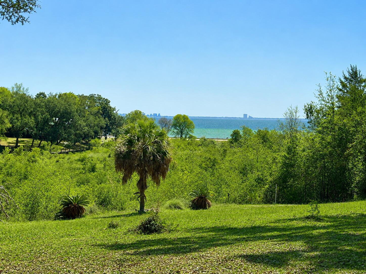 UNMATCHED PRIVACY, SPECTACULAR VIEWS, & ULTIMATE NICEVILLE PARADISE ON 1.62 ACRES! Nestled on an expansive 1.62-acre double-lot estate encompassing 2 parcels, this one-of-a-kind Niceville property offers the ultimate blend of coastal proximity and secluded serenity. Backing up directly to protected Eglin AFB land, your peace and privacy are permanently guaranteed.
Drink in spectacular, panoramic views of the Choctawhatchee Bay and overlook the serene secluded bayou waters of Grass Lake. Inside the brick home, an incredibly spacious layout anchored by original, retro-style decor and durable tile throughout--offering a fantastic, solid canvas for vintage design lovers or anyone looking to customize their dream coastal retreat. The 1.62-acre grounds feature a spectacular, park-like setting that effortlessly blends natural beauty with functional open space. A meticulously cleared, expansive lawn offers plenty of room for outdoor activities, pets, or perhaps even future additions, while mature, swaying palm trees adjorn the property to create an unmistakable, relaxed vibe. Own a private, sun-drenched sanctuary right by the water with NO HOA!
The property boasts an Ultimate Hobbyist & Adventure setup for auto enthusiasts or craft lover, alike. 
An Oversized 4-Car Garage has a massive footprint with ample room for multiple vehicles, toys, and gear.
A dedicated Mechanic Shop is fully ready for projects, heavy tools, and specialized work. A must see! Beside the garage is a covered RV Carport with high-clearance protection and will keep your motorhome, boat, or camper safe from the elements.
Do not disturb! Appointments must be scheduled to view the home and/or property.
Listing agents have resourced parcel/property information from the Walton County Property Appraiser's website. While the acquired information is deemed accurate and true, the buyer and/or buyer's agent should verify all details related to this property prior to purchase. The Listing agent and/or Lokation Real Estate broker do  not warranty, nor guarantee, this MLS data to be accurate or true. Buyers are to perform their own due diligence and verify all information regarding the parcel and home prior to making their decision to purchase.