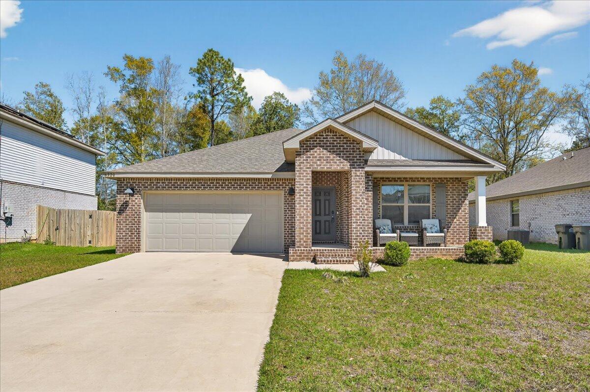 MOVE-IN READY! This is a beautifully maintained 4-bedroom, 2-bathroom was built in 2022 and nestled in a quiet, well-kept neighborhood. This home is ideally located near I-10, Navy Federal Credit Union, and local schools. Step inside to a bright, open-concept layout featuring a neutral color palette, recessed lighting, and seamless flow between the living, dining, and kitchen areas. The kitchen is a standout with its large granite-topped island, white shaker-style soft-close cabinets, stainless steel appliances, spacious pantry, and breakfast bar for additional seating. The split floorplan offers privacy, with a generously sized primary suite tucked away from the other bedrooms. The en-suite bathroom includes double vanities, a walk-in shower, water closet, linen closet, and a large walk-i n closet for plenty of storage. Three additional bedrooms are thoughtfully positioned throughout the home, each with carpeted flooring, with a full bathroom nearby with a tub/shower combo. Enjoy outdoor living with both front and rear covered patios, plus the added convenience of a 2-car garage. This home truly checks all the boxes, modern features, functional design, and a prime location all in one!