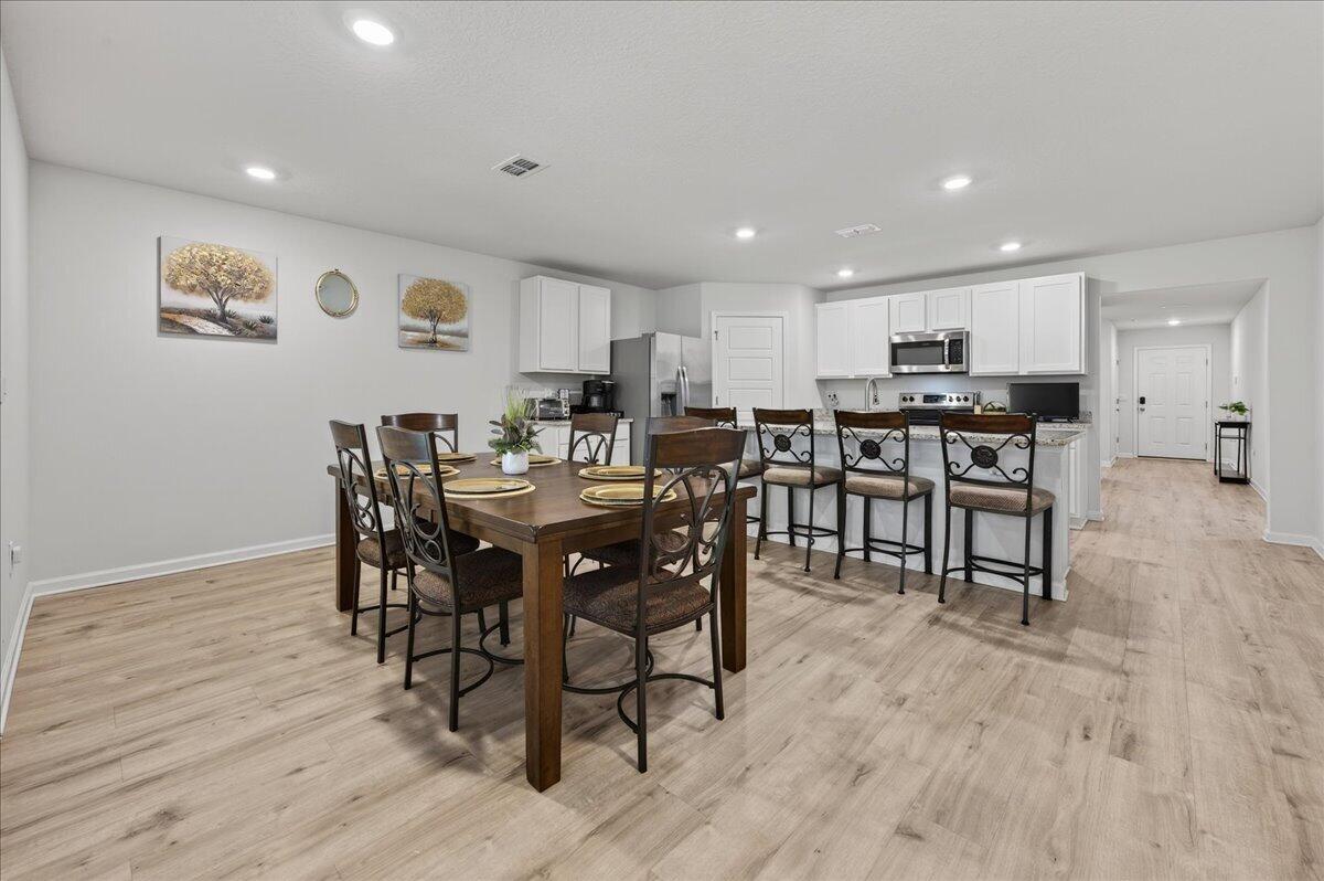 MOVE-IN READY! This is a beautifully maintained 4-bedroom, 2-bathroom was built in 2022 and nestled in a quiet, well-kept neighborhood. This home is ideally located near I-10, Navy Federal Credit Union, and local schools. Step inside to a bright, open-concept layout featuring a neutral color palette, recessed lighting, and seamless flow between the living, dining, and kitchen areas. The kitchen is a standout with its large granite-topped island, white shaker-style soft-close cabinets, stainless steel appliances, spacious pantry, and breakfast bar for additional seating. The split floorplan offers privacy, with a generously sized primary suite tucked away from the other bedrooms. The en-suite bathroom includes double vanities, a walk-in shower, water closet, linen closet, and a large walk-i n closet for plenty of storage. Three additional bedrooms are thoughtfully positioned throughout the home, each with carpeted flooring, with a full bathroom nearby with a tub/shower combo. Enjoy outdoor living with both front and rear covered patios, plus the added convenience of a 2-car garage. This home truly checks all the boxes, modern features, functional design, and a prime location all in one!