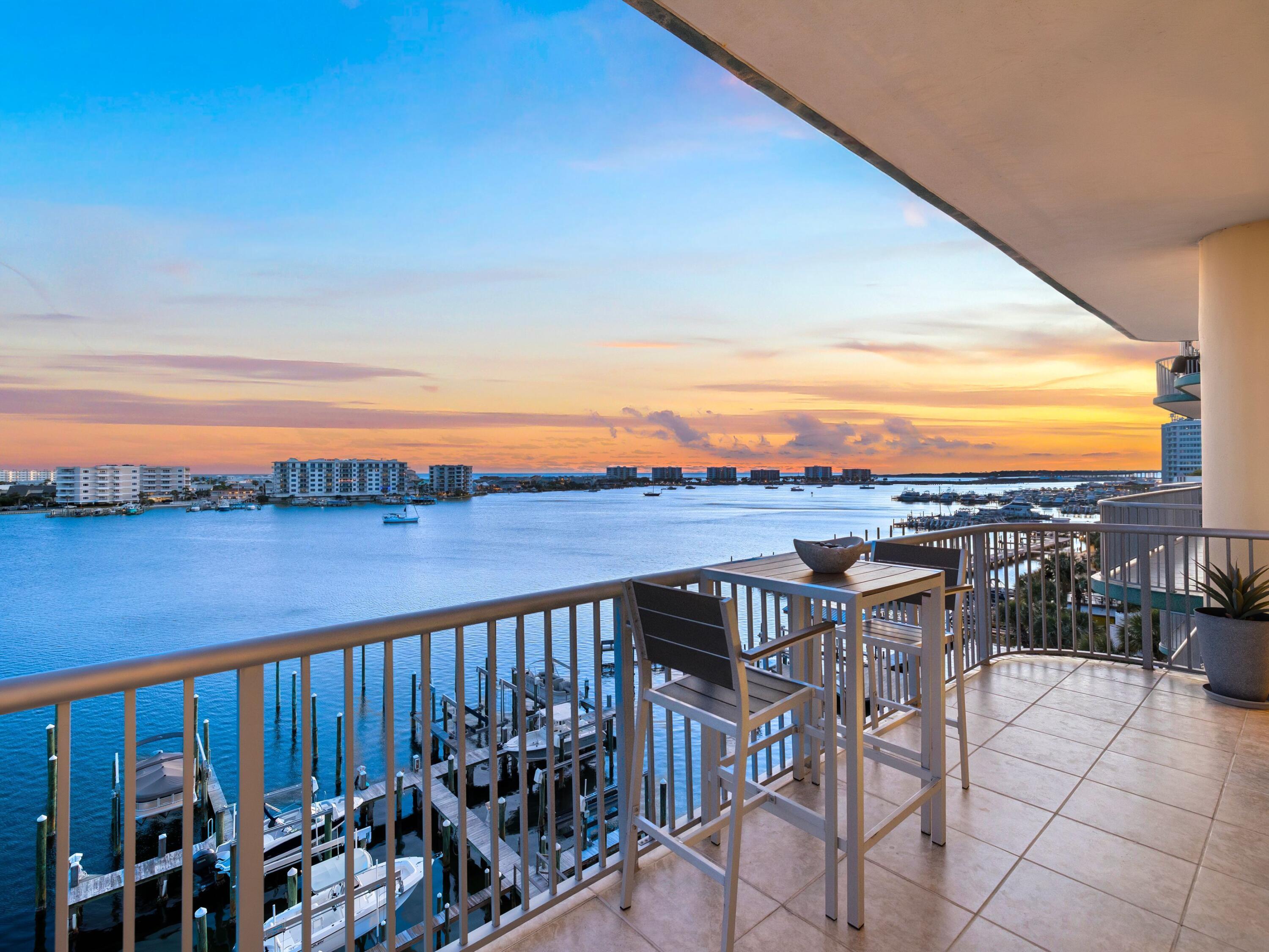 Welcome to Harbor Place 401 -- a rare opportunity to own within one of Destin Harbor's most intimate and owner-oriented waterfront communities. Tucked within a boutique five-story condominium comprised of just 12 residences, this corner unit offers a quieter, more residential approach to harbor-front living.

With rental restrictions prohibiting short-term rentals, Harbor Place is uniquely suited for buyers seeking privacy, low density, and a more relaxed ownership experience with less transient traffic and vacation turnover. Unlike many of the larger resort-style condominium communities along the harbor, Harbor Place offers a true residential atmosphere in the heart of Destin's waterfront district. Inside, the approximately 1,315-square-foot residence is filled with natural light from wraparound floor-to-ceiling windows that frame beautiful harbor views and glimpses toward the Gulf. The two-bedroom, two-bath layout offers an inviting coastal retreat equally suited for full-time living or a second home.

The kitchen is equipped with Samsung appliances, an LG electric range and cooktop, GE Adora dishwasher, and Whirlpool Gold icemaker. Additional features include powered blinds in the living areas and bedrooms, a lift TV in the primary suite, and a mechanical bed for added comfort and convenience.

Conveniently located along the harbor, Harbor Place is within walking distance to several of Destin's favorite waterfront dining destinations, including Marina Cafe, Boshamps, and Harbor Docks. Owners may also enjoy the convenience of harbor water taxi service with pick-up available directly from the community dock.

Residents enjoy a swimming pool, fitness center, rooftop observation deck overlooking the harbor, dedicated owner storage, and a community dock with direct harbor access--ideal for waterfront enjoyment. Additional community features include a gated building entrance, private parking with 24 trellised parking spaces shared among only 12 residences, a paddleboard and kayak storage hut along the shoreline, and an approximately 8' x 10' secure storage space located in the building's basement level.

Harbor Place 401 is for the buyer seeking harbor living without the chaos of a vacation-rental environment -- a hidden residential gem offering privacy, waterfront beauty, and a true sense of ownership along the Destin Harbor.