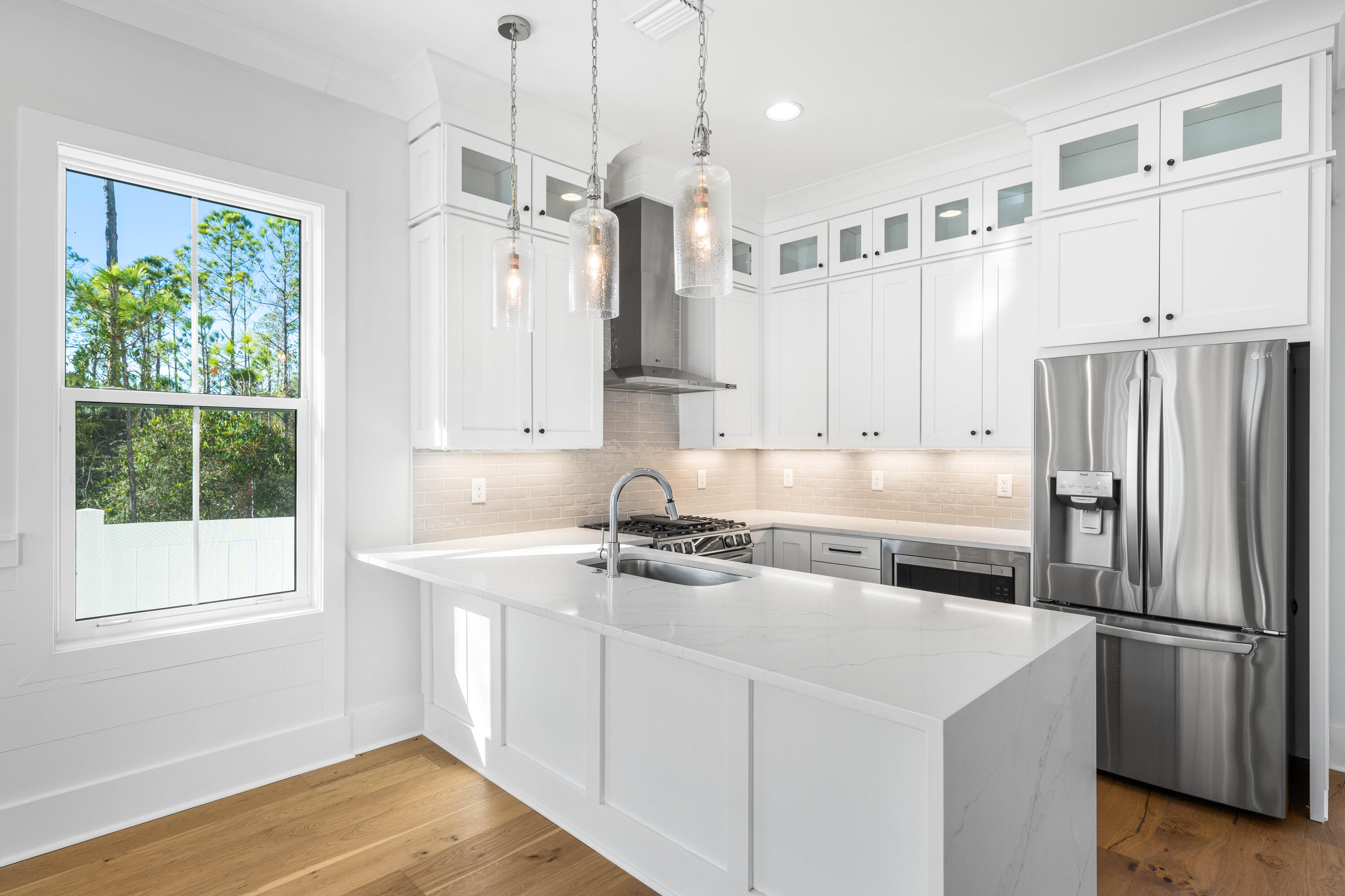 Welcome to Century 393, the newest and most exciting townhome development in Santa Rosa Beach, Florida. Perfectly positioned at 520 S Co Hwy 393, this exclusive community offers unparalleled access to 30A's best just a three-minute golf cart ride to Ed Walline Beach, Shunk Gulley, Papa Surf Burger Bar, and the lively Gulf Place town center. Unit #40A boasts 1,914 square feet of heated and cooled living space, with 2,412 square feet under roof. Designed for modern coastal living, this three-bedroom, four-and-a-half-bath townhome features a versatile bunk room, high-end finishes, an outdoor kitchen, and a fully fenced backyard with private hot tub making it an ideal personal retreat. The open-concept first floor seamlessly connects the living, dining, and kitchen areas,