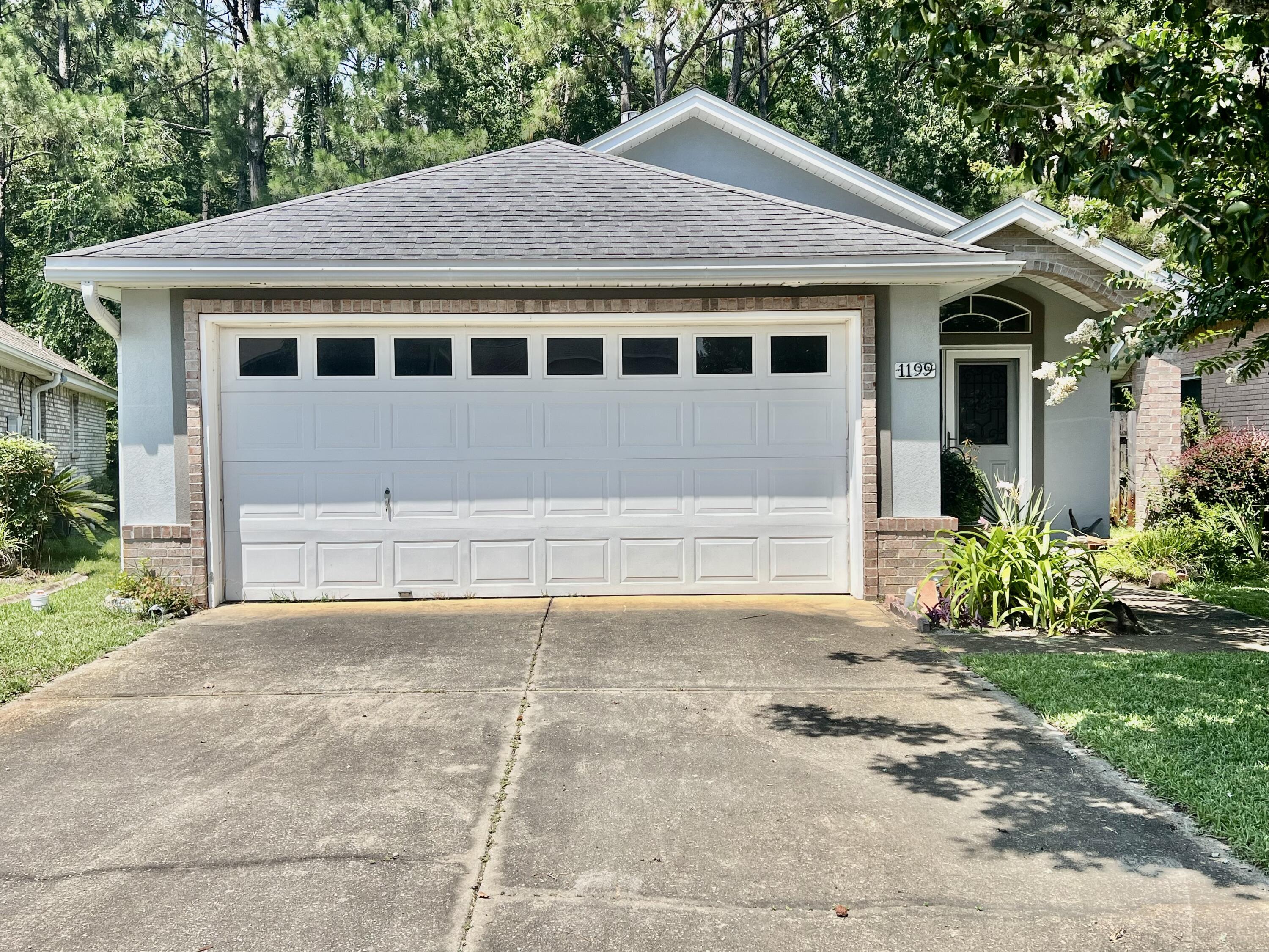Welcome home to this beautifully maintained, move-in ready home in the desirable Northridge Creek community!  A charming covered front porch, accented by a beautiful crape myrtle, creates a warm first impression.  Inside, you'll love the open concept layout with tray ceilings, a spacious family room with a gas fireplace, and a kitchen featuring stainless steel appliance and a breakfast bar - perfect for entertaining.  Tile and wood flooring flow throughout the main living areas.  The split bedroom floor plan offers privacy for guests, while the generous primary suite includes private access to the screened porch and an ensuite bath with a walk in shower with built in seating as well as the walk in closet.  Relax on the screened porch overlooking a private, fenced backyard with mature trees.  Roof replaced in 2014.  Two car garage, spacious laundry room, low annual HOA, plus a community gazebo and boardwalk just a short stroll away.  This community has 117 single family homes.  All information and dimensions are to be verified by the buyer prior to closing.