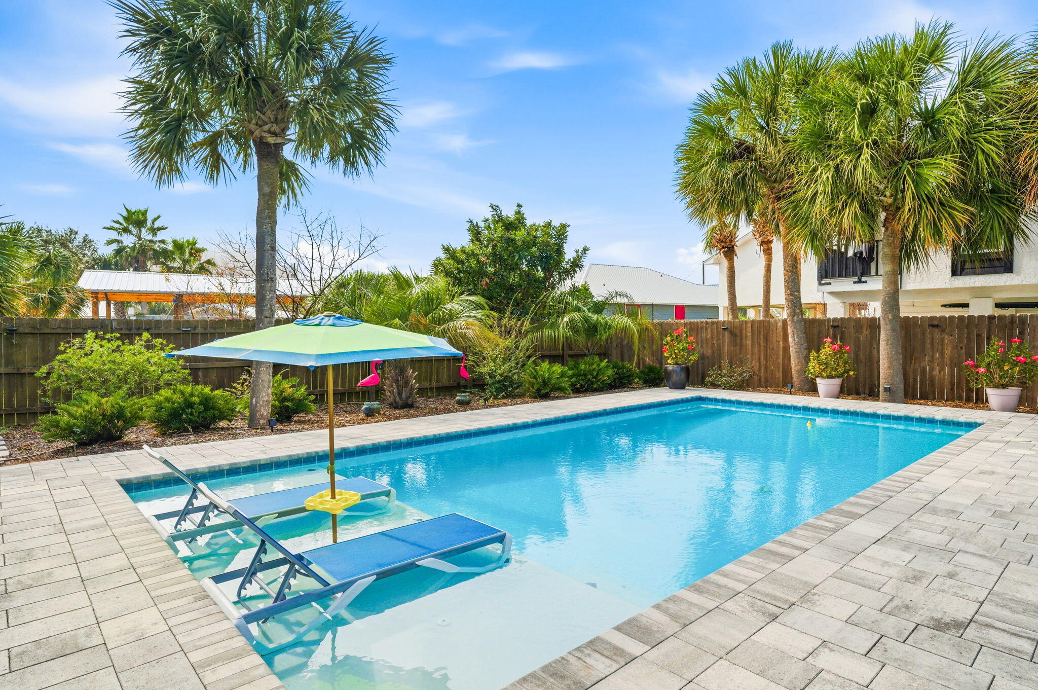 This fabulous double-lot (1/3 acre) resort home with a pool is perfectly situated on South Lagoon in the heart of Panama City Beach's highly desirable east end. Just a short walk to the World's Most Beautiful Beaches and Grand Lagoon, this prime location also offers 2 nearby boat ramps with lagoon access to the Gulf. This inviting, one-of-a-kind custom beach home features soaring 16-foot ceilings in the living room, beautiful LVP flooring, coastal colors, shiplap accents, three spacious bedrooms, stainless steel appliances, and granite countertops. Outdoor living truly shines with multiple entertaining spaces, a pool added in 2021, and a brand-new relaxing hot tub. The possibilities are endless...use as a primary residence, a relaxing personal resort, a high- high-performing vacation rental, or divide the lots and build on the second parcel. Additional features include a standing-seam metal roof, a two-car garage, a separate storage shed, and a private well for the sprinkler system. Located in a golf-cart-friendly neighborhood with no HOA, you'll enjoy easy access to the beach, Grand Lagoon, St. Andrews State Park, boating, dining, and entertainment. Call today to make this exceptional property your primary home, vacation getaway, or investment opportunity!