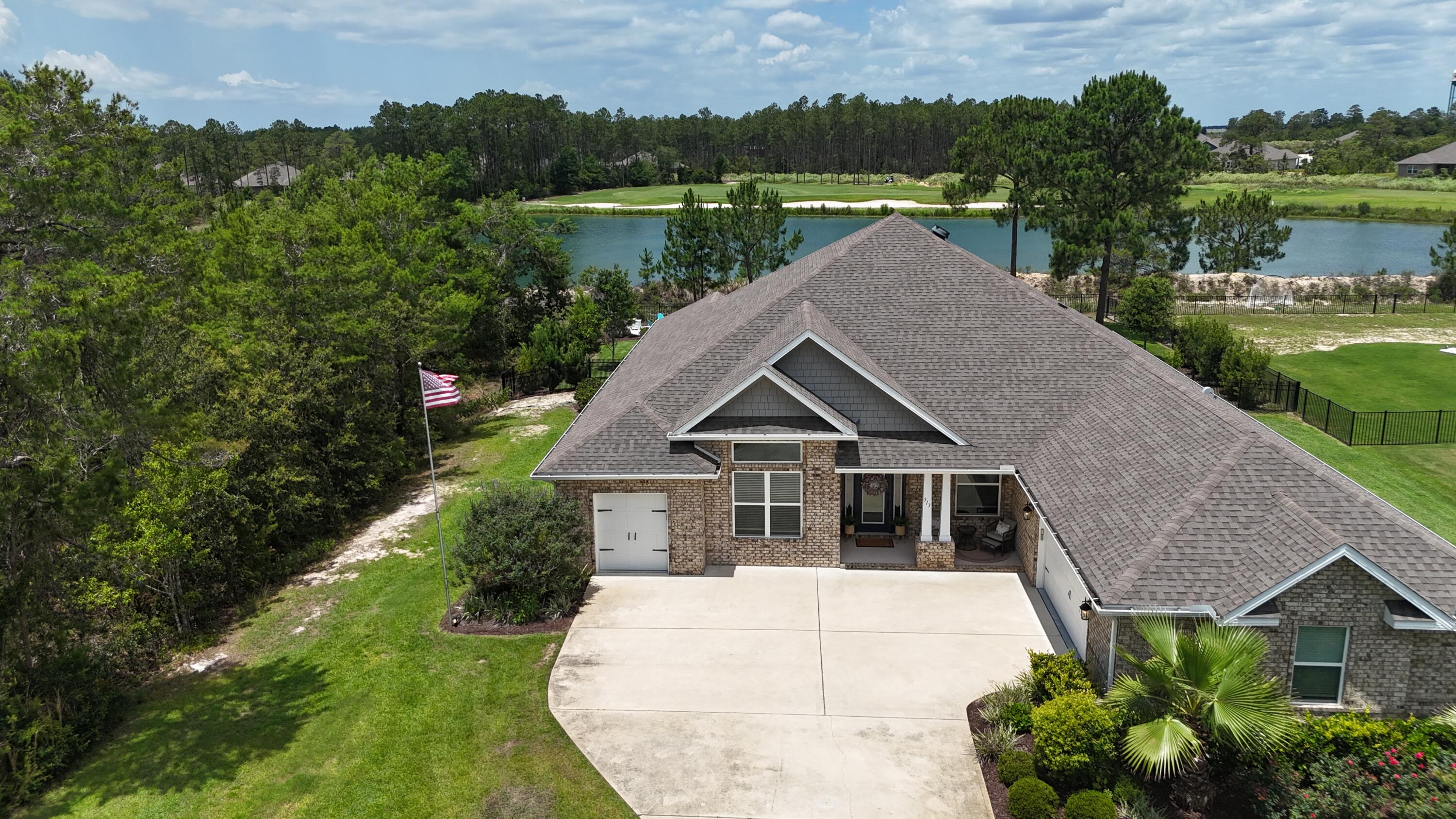 ***$10,000 Buyer Credit Opportunity!*** Welcome to this beautifully designed 2020-built home situated on a .59 acre premium golf course lot with peaceful water views and a spacious fenced backyard. Offering the perfect blend of luxury and functionality, this property is built for both comfort and entertaining. Enjoy ample parking with a two-car garage plus a separate golf cart garage -- all with epoxy flooring. Additional upgrades such as a tornado shelter and reverse osmosis system. The private backyard retreat is a showstopper featuring a screened porch, fire pit, putt-putt area, and a 15x25 gunite sports pool with heating and cooling, tanning ledge, bubblers, and autofill. Inside, you'll find abundant natural light, hard surface flooring, raised ceilings, curved archways , and both formal and informal living and dining spaces anchored by a cozy fireplace. The chef's kitchen features white quartz countertops, a large island with breakfast bar, smooth surface range, and an oversized walk-in pantry. The primary suite includes a flexible bonus area ideal for a home office, nursery, or gym. Luxury, recreation, and thoughtful upgrades   all in one exceptional home. Windswept amenities include pickle ball, tennis, basketball, playground, pool and more!
Lot next door is available, it's .59 acre and allows for the privacy or create your own estate.