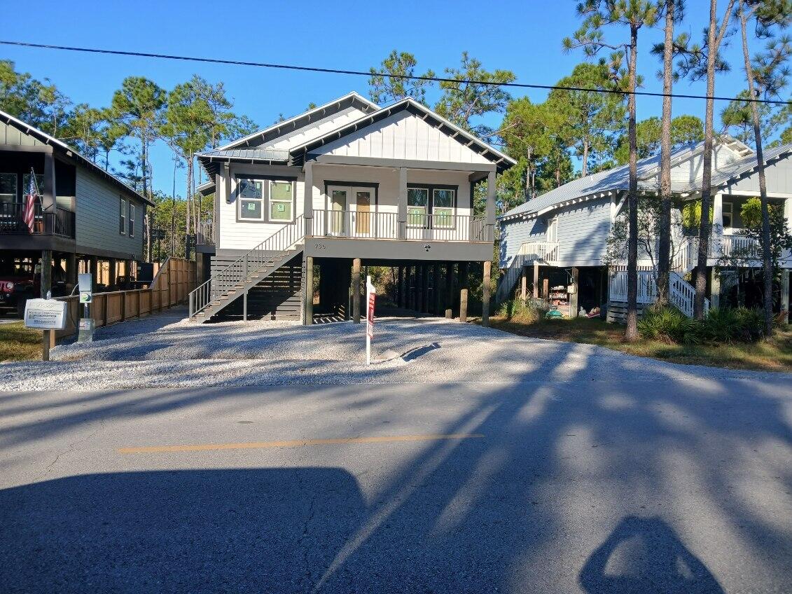 PRICE IMPROVEMENT by $15k! Minutes from Beach & Bayou with Boat Launch!  Open Great Room & Country Kitchen featuring quartz countertops, recessed lighting, custom cabinetry, and a spacious pantry with built-in shelving. Stainless Steel Frigidaire Appliances, Kitchen Island with Breakfast Bar, and Dining area.  Separate Entrance to Laundry Room (off Kitchen) with Washer & Dryer. Inviting, Light-Filled Master Suite with roomy Walk-In Closet with custom built-in shelving, large Master Bath featuring designer tile & fixtures. Charming Barn Door. Enjoy fresh morning air w/coffee on the Master Balcony! Off the hall are two more generous bedrooms with roomy closets.  Easy maintenance laminate flooring! Lovely home or potential Airbnb. One Year Warranty from Builder!