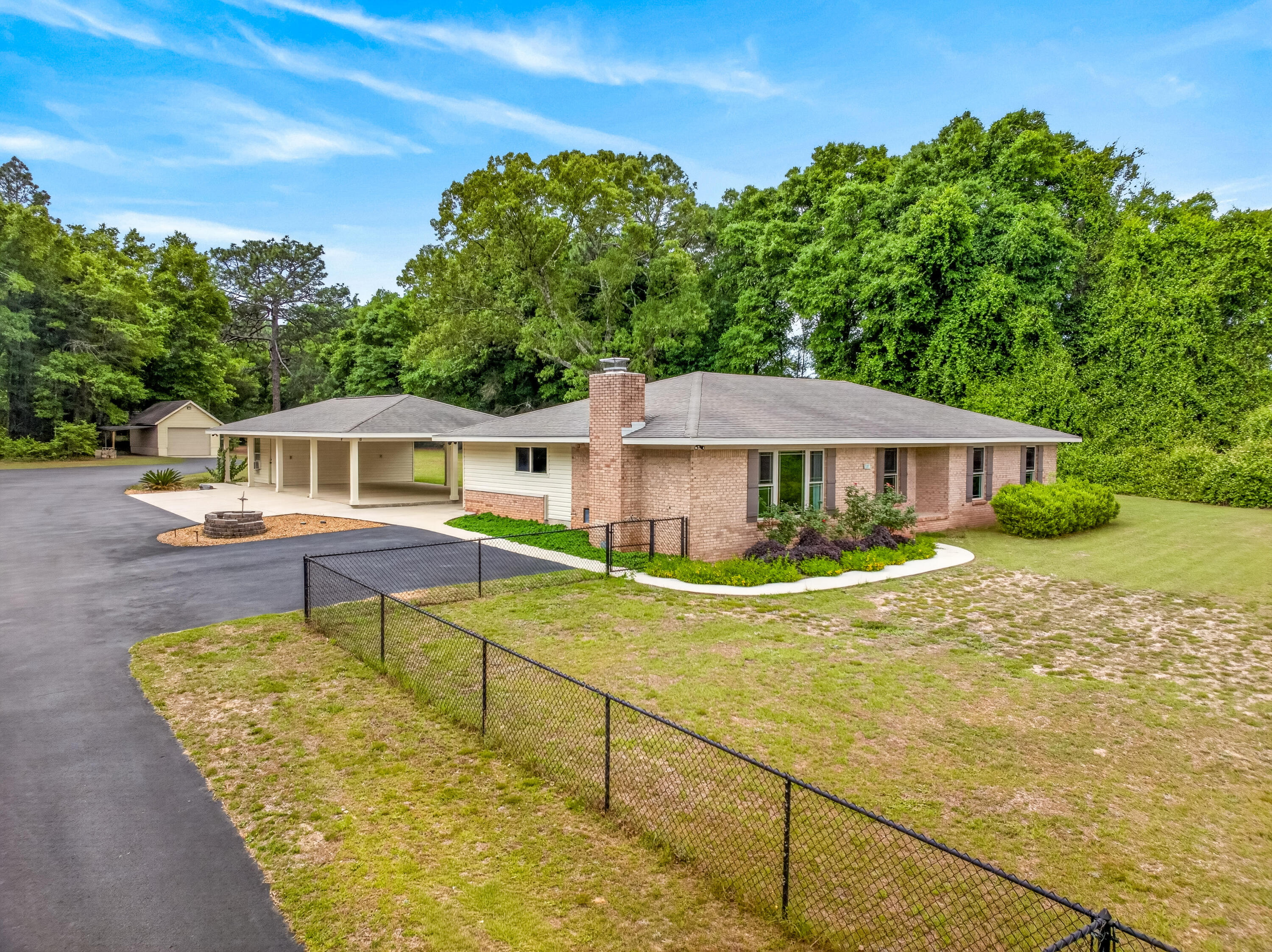 Contract pending with '72 hour Kick-out Clause' - taking back up contract.  Seller will pay $23,000 toward Buyer's closing costs with acceptable offer. Your own private retreat-five acres just minutes from town, where nature and comfort meet in perfect balance. Beautifully renovated 3-bedroom, 2-bath home (2014 updated) offers modern living surrounded by the charm of country life. Wood FPL. Master BR has 2 closets, one is a walk-in. New HVAC system 4/22/26. Property is a dream for hobbyists, adventurers, and anyone needing space: an attached 3-car carport, expansive 24x48 RV garage, detached 1-car garage, a shop, tool shed, and a greenhouse for your gardening passions. Wander through the land and discover flourishing blueberry bushes and a serene wooded backdrop with winding trails-perfect for morning walks, quiet reflection, or weekend exploration. R1 Zoning. See Features Sheet in the Document Section.