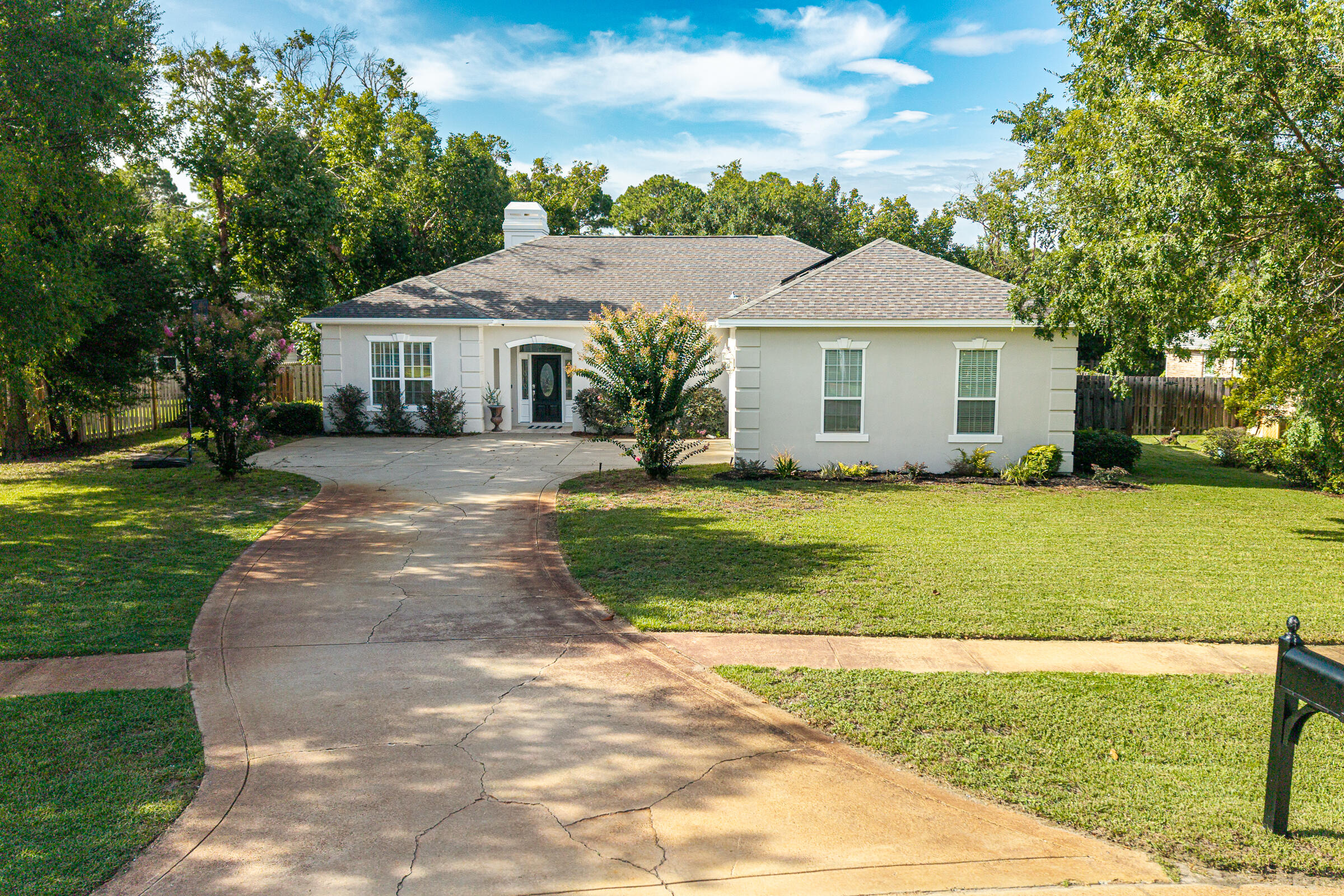 Welcome to this beautifully designed one-level home in the highly desirable Windsor Forest neighborhood of Destin. Featuring a sought-after split floor plan, this residence offers both privacy and functionality for everyday living. New luxury vinyl plank (LVP) flooring flows throughout the home, creating a fresh, modern look that's both stylish and easy to maintain.

The oversized primary suite serves as a relaxing retreat, complete with a grand ensuite bathroom featuring generous space to unwind. Guests will appreciate the convenient half bath, while the spacious kitchen is the heart of the home, offering a breakfast bar with ample seating that flows seamlessly into the living and dining areas--perfect for entertaining family and friends.

Step outside to the screened porch, an ideal spot to enjoy your morning coffee or evening gatherings while overlooking the expansive backyard. With plenty of room to add a pool, the outdoor space offers endless possibilities for creating your own private oasis.

Located in the established Indian Trail community, this home is just minutes from Destin's white-sand beaches, boating, shopping, dining, and top-rated schools, making it an exceptional place to call home.
