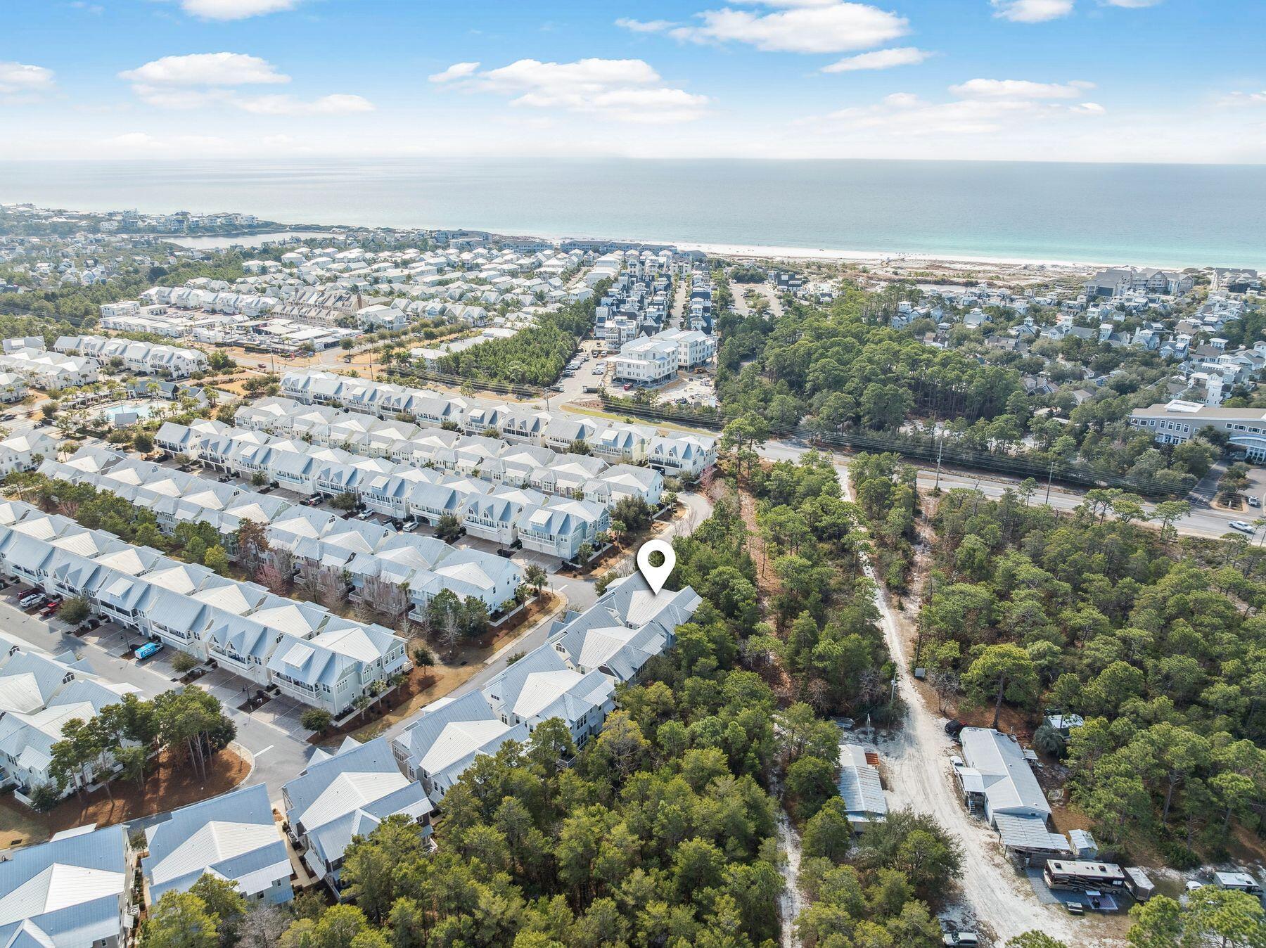 Completely surrounded by lush preserved land, this highly desirable A unit in the neighborhood of Prominence offers the best combination of privacy and convenience with a newly replaced HVAC. Bordering wooded areas yet near the front of the neighborhood, this A unit offers close proximity to neighborhood amenities, the shops and local restaurants of The Big Chill and the bike path running along Scenic Highway 30A. With immense natural light, the living and dining areas provide ample space to entertain or relax with family and friends after a long day at the beach. The bright coastal decor offers a fresh and inviting retreat. The kitchen is designed with the modern chef in mind with a gas range, gleaming stainless steel appliances, pristine granite countertops and a large center island with a breakfast bar.art Beyond the living area, double doors lead to the rear porch perfect for alfresco dining or morning coffee with tree-lined views. The first level is also nicely appointed with a powder bathroom, dedicated laundry room and spacious owner's closet. A staircase leads to the second level where the master suite along with two guest bedrooms and a shared full bathroom can be found. The master suite offers large windows overlooking the preserved land with ample natural light flowing through and a large bathroom with a walk-in shower, double vanity and spacious walk-in closet. The two spacious guest suites offer wooded views and access across the hallway to a full guest bathroom. The location of this home is perfectly suited as both a rental investment and second home. The private two-car attached garage is an added convenience for those wanting to store the included six-seater golf cart, bicycles and beach toys or personal vehicles. Prominence offers many community amenities including a large lagoon-style pool, grilling areas and a fitness room. The Big Chill is located in the heart of Prominence hosting an array of community events, football game viewing, concerts, shopping and popular local eateries.