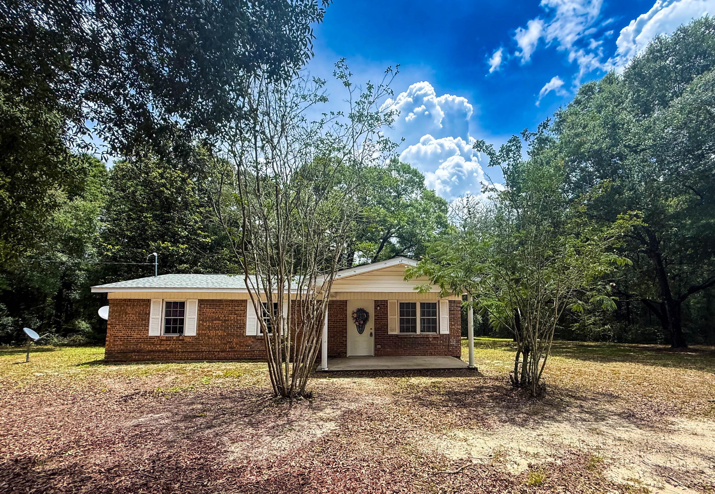 This 4BR/2BA home will sit on approximately 2 acres and has had all the major updates completed, including a newer roof, HVAC, flooring, electrical, and septic. The roof was replaced in March and the HVAC and electrical wiring in July! The home features a split floor plan, fireplace and a versatile bonus room that can be used as an office, dining area, or flex space. Mature oak trees and azaleas adorn the property giving it that country Florida vibe. There's plenty of room for your horses, chickens, or garden! Located on Old River Road, the property offers the peace and quiet of country living while remaining convenient to Crestview. The landscaping is a blank canvas, and ready for your personal touch. Contact me today to schedule a private showing!
