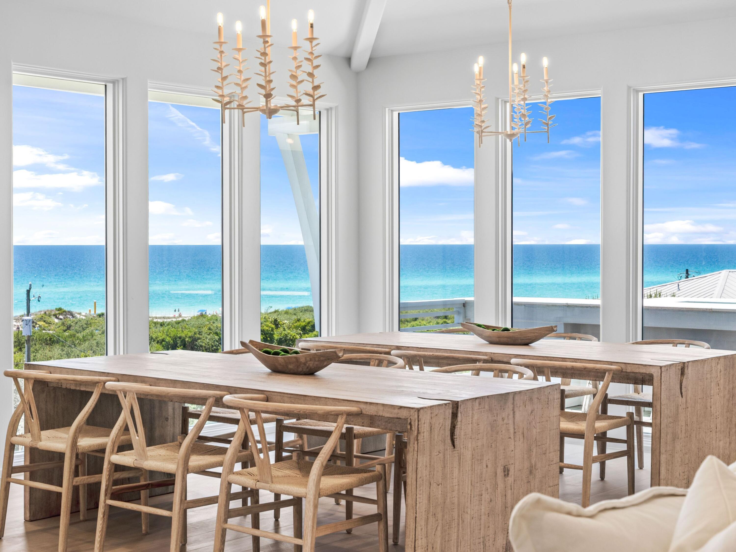A rare opportunity just steps from the Gulf, this four-level custom home in the community of Mala Beach represents a standard of construction with features rarely seen on the Emerald Coast. Built as a personal home, every material and finish was hand curated -- and it is evident throughout the residence. Spanning an immaculate 6,018 square feet with an elevator servicing all levels, there are four spacious primary suites with king beds and  two bunk rooms.  The first floor sets the coastal tone with a large open living area with Peacock paver floors and floor-to-ceiling Jeldwen windows allowing in a multitude of light.  A dining area, marble wet bar with sink and refrigerator, powder bath, laundry and connected garage which is currently being used as a game room complete this level. The second floor hosts two of the four primary suites, both with an all-marble bathroom featuring a freestanding soaking tub, rain head shower, and floating vanities, along with private balcony access. Also on this level are the two generously sized bunk rooms, each sleeping five guests across three singles and one full sized lower bunk, and each with a dedicated bathroom with large walk-in shower. The third floor delivers two additional king primary suites, both with direct balcony access and Gulf views. The bathrooms are equally impressive with freestanding tubs, oversized marble showers with ceiling-mounted rain heads, and dual floating vanities with Carrara marble countertops. Every bedroom in this home has been finished with the same uncompromising attention to detail; the only difficult decision will be choosing which one to claim. The fourth floor is the crown jewel of the home. A dramatic vaulted ceiling opens over a fully integrated living, dining, and kitchen space. The chef's kitchen anchors the room with a handcrafted La Cornue range that draws attention the moment you walk in, a paneled SubZero refrigerator, Italian-made cabinetry and honed Carrara marble countertops. The powder room on this level is finished in hand-made Moroccan Zellige tile. Euro Wall sliding doors open the entire living space to the magnificent rooftop deck complete with heated pool. In total, the home offers over 1,000 square feet of outdoor living space across all levels. Designed to embrace its stunning surroundings, the floor plan seamlessly flows from indoor to outdoor spaces, offering views of the majestic Gulf waters and the picturesque white beaches. This remarkable retreat is a must-see for the discerning buyer seeking the ultimate blend of serenity, style, and coastal charm. Mala Beach is a seven-home Gulf-front community in Inlet Beach, just steps from one of Walton County's best beach accesses and minutes from Alys Beach, Rosemary Beach, 30Avenue and all of the shopping and dining venues.