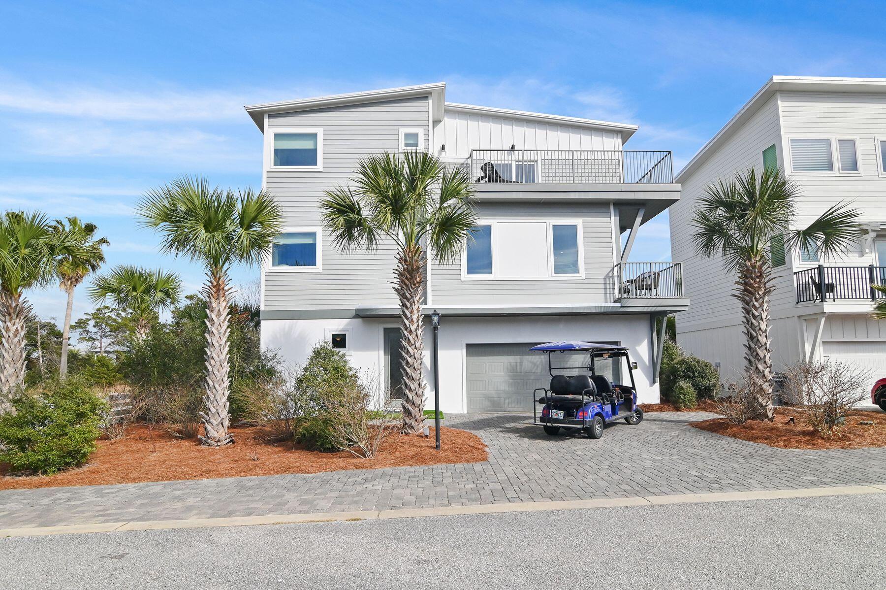 Just minutes from the white sand in Inlet Beach, this beautifully designed three-story coastal retreat offers the ultimate 30A lifestyle. Enjoy seven nearby public beach access points with parking and restrooms, the closest being access beside Camp Helen State Park, where the beach is wide open and less crowded. The new Highway 98 pedestrian underpass also provides safe, convenient access to both the beach and 30A, making this an ideal vacation getaway or investment property.  Built in 2018 and recently refreshed, this four-bedroom, four-bathroom home spans 2,196 square feet and comes turnkey and fully furnished, complete with a six-seat golf cart. Thoughtful updates include new exterior paint, wainscot in stairwells, new balcony decking, and new flooring on the second level, ensuring a move-in-ready experience. Inside, you'll find two living areas designed for comfort and entertaining. The first floor offers a cozy living space with a three-bunk bedroom, full bath, laundry, and patio access. The second floor includes an open-concept kitchen, living, and dining area with a balcony, plus a guest bedroom and full bath. The third floor hosts the primary suite with double vanities, walk-in closet, walk-in shower, and sun deck, along with an additional ensuite bedroom with deck access. This stylish home comfortably sleeps 11 or more guests and offers multiple outdoor spaces, including a balcony, deck, a fenced backyard patio, and low-maintenance artificial turf, making it easy for coastal living. Soak up the sun at the community pool shared by only a few homesites, bike to 30A , and enjoy the convenience of a rare two-car garage plus driveway parking for two to three additional vehicles. Stroll to nearby dining, boutiques, and cozy coffee shops, or take a quick bike, golf cart, or car ride to 30Avenue for even more shopping, dining and entertainment. With impressive rental projections of $65,000 to $97,000 annually, this turnkey beach retreat offers the perfect blend of smart investment potential and effortless coastal living. Discover the charm, convenience, and laid-back luxury that make Inlet Beach so special.  Buyer should verify all data and approximate dimensions, if important.