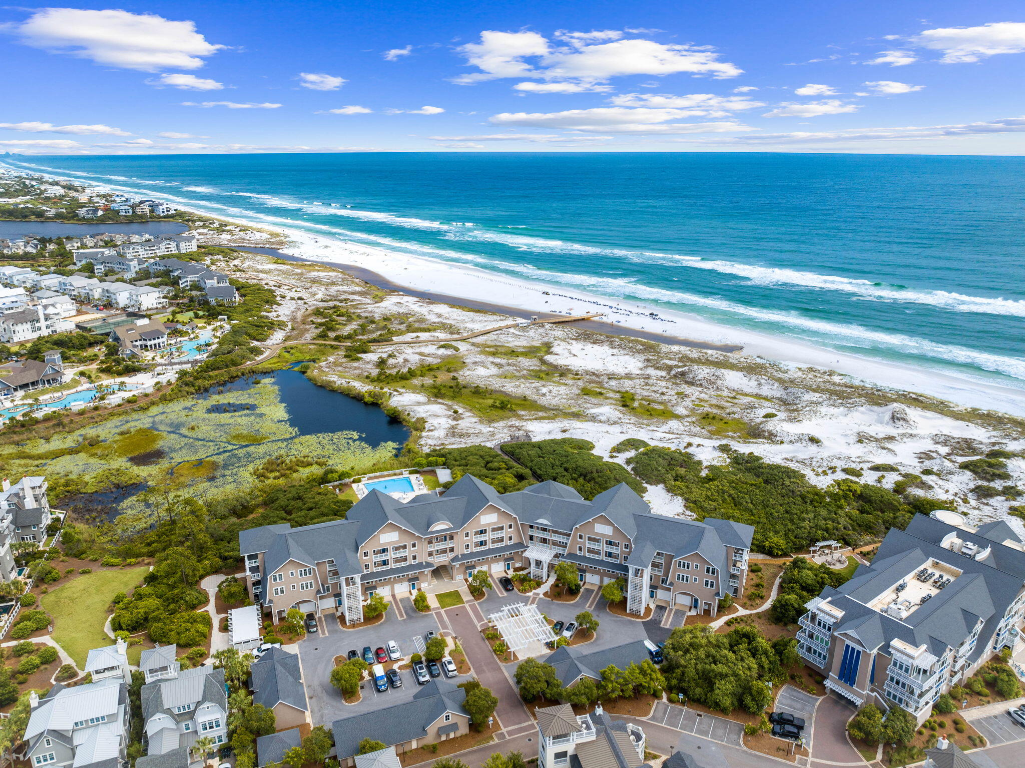 Experience the best of WaterSound Beach from this beautifully updated residence in Compass Point, one of 30A's most exclusive Gulf-front condominium communities. Perfectly positioned among the iconic sugar-white dunes of Watersound Beach, Compass Point 110 offers the rare combination of privacy, luxury, and effortless coastal living just steps from the beach, multiple pools, and WaterSound Beach Club. Offering 2,280 square feet of thoughtfully designed living space, this Gulf Front condo features 3 bedrooms, 3 1/2 baths, and a custom-built bunk room. Offered fully furnished and turnkey, this lovely property makes for a great 2nd home or Vacation Rental Property. Positioned in one of WaterSound Beach's most sought-after condominium buildings, this two-story residence enjoys serene views of the community's protected Gulf-front dunes with glimpses of the emerald waters beyond. Expansive covered porches extend the living space outdoors, including a private screened porch off the primary suite--a peaceful setting for morning coffee or evening relaxation surrounded by the sights and sounds of the coast. Recent improvements include tasteful updates and remodeling, complemented by a sophisticated furnishings and decor package curated by renowned designer Laura McKee of L. Hamilton & Company. The result is a timeless coastal aesthetic that feels both elevated and inviting. The open-concept living and dining areas are designed for effortless entertaining, while the spacious bedroom layout provides privacy and comfort for owners and guests alike. The custom bunk room adds additional sleeping capacity, enhancing the property's appeal for larger families and vacation rental guests.
Owners enjoy immediate access to the private Compass Point pool, community pools, and multiple beach boardwalks leading to WaterSound Beach's pristine shoreline. The property's central location within the community also provides convenient access to the coveted WaterSound Beach Club and the extensive network of walking paths, boardwalks, and green spaces that define the WaterSound lifestyle. Call and schedule a Private Showing of this timeless beach residence today!