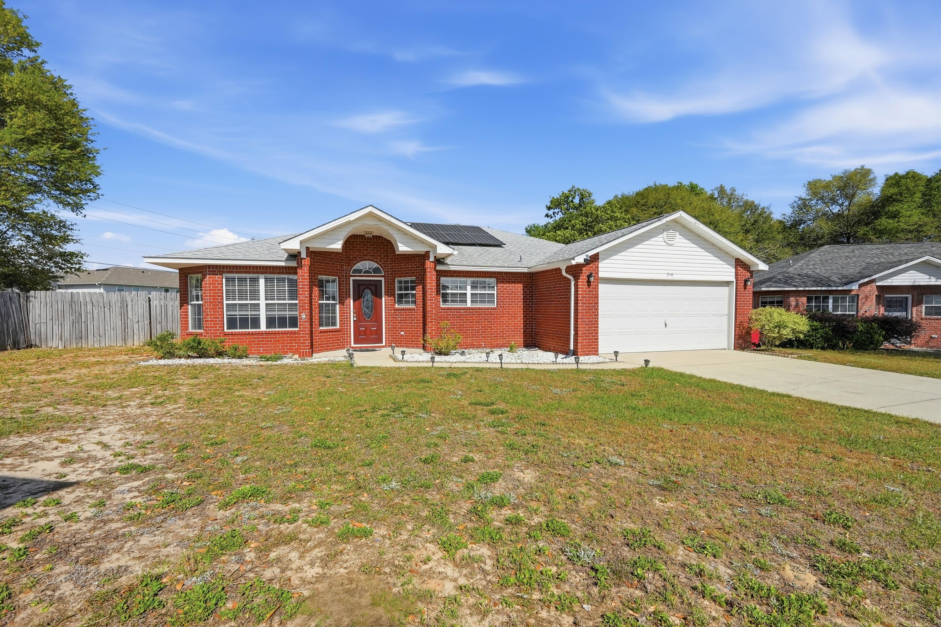 Welcome to this charming 3-bedroom, 2-bathroom home in central Crestview! Featuring a desirable split floor plan, this home offers both comfort and privacy for everyday living. The spacious eat-in kitchen is perfect for gathering, complete with a center island and pantry that provide ample storage and prep space. The open living area is filled with natural light and features elegant French doors that lead out to a large, fully fenced backyard with raised garden beds--perfect for entertaining, gardening or relaxing outdoors. The generously sized primary suite offers a peaceful retreat with a double vanity and plenty of space to unwind. Additional highlights include a two-car garage and energy-saving solar panels (monthly electric/solar fee applies) making this home as efficient as it is welcoming. Conveniently located near shopping, schools, and just a short drive to Duke Field and Eglin Air Force Base, this home offers both convenience and accessibility. Contact us today for a showing!