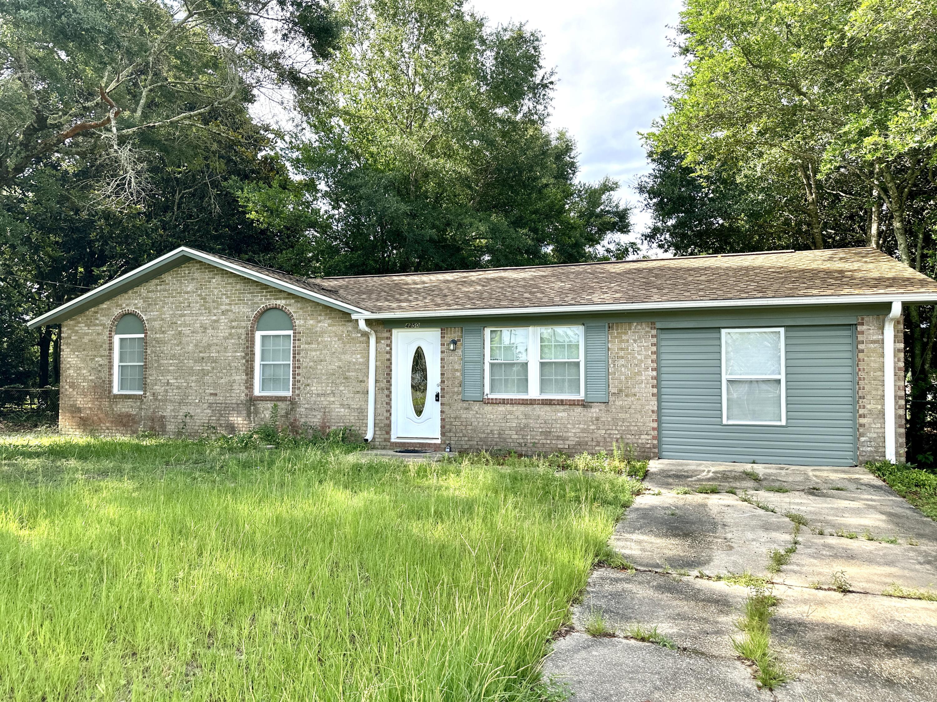 Welcome to this move-in ready brick ranch home, perfectly situated on a spacious corner lot. This home features a functional layout with modern updates including tile flooring throughout. The kitchen has stainless steel appliances and ample cabinet space. Enjoy nicely-sized bedrooms and updated finishes including a large bonus room with its own access to the backyard, perfect for a flex space  or second living area. The screened-in porch is ideal for relaxing, while the spacious yard with mature trees provides plenty of room to spread out with room for a pool, boat and/or RV. Conveniently located right off Highway 90, and tucked away in the peaceful, low-traffic Pine Villa neighborhood with no HOA fees. this house provides for quicker commutes to Milton, Pensacola and NAS Whiting Field. New roof in 2025. Also qualifies for USDA financing.