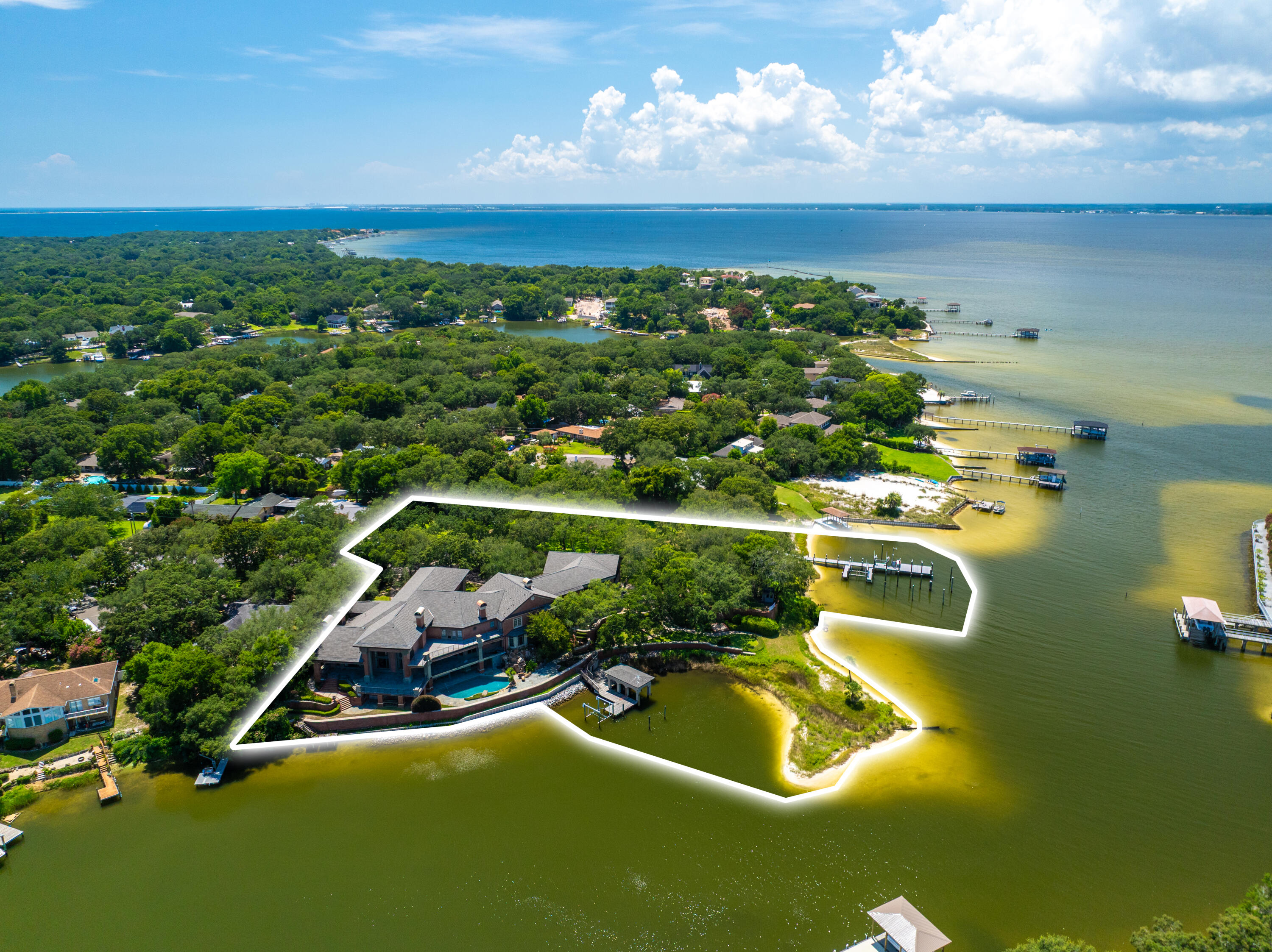 PREMIERE WATERFRONT ESTATE -- REIMAGINED FOR MODERN COASTAL LIVING

Set along 825 feet of Pensacola Bay shoreline on 2.98 acres, 204 Laura Lane presents a rare opportunity to reimagine a legacy waterfront estate. Spanning over 14,000 sq ft, the home offers grand scale, timeless architecture, and over 6,000 sq ft of terraces designed for seamless indoor-outdoor living, entertaining, and sunset views. The existing layout includes a chef's kitchen, formal living spaces, and a private primary suite with sweeping water vistas--ready to be refined into a modern coastal masterpiece. With two deep-water docks, multiple guest suites, and panoramic views, this property offers unmatched potential just minutes from downtown Pensacola and Pensacola Beach. Also offered as MLS #1002228 & #990457.
