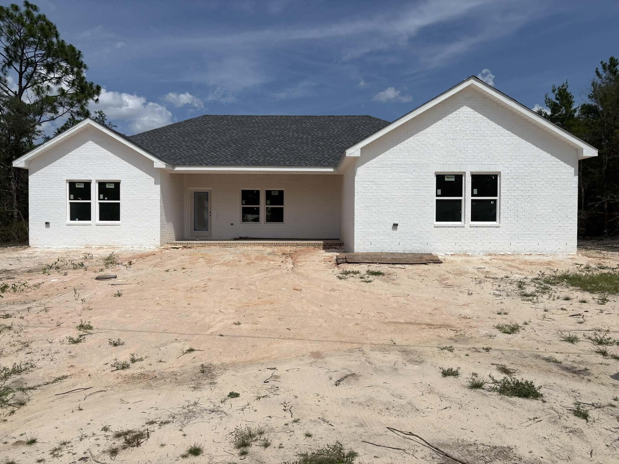 NEW CONSTRUCTION underway in DeFuniak Springs! This brand-new 4-bedroom, 3-bath home offers approximately 1,811 heated square feet with a spacious open-concept layout and split-bedroom floor plan designed for both comfort and functionality. Situated on approximately 0.49 acres, this home features a large family room, spacious kitchen with island seating, dining area, indoor laundry room, covered front porch, and rear covered patio perfect for relaxing or entertaining.

The private primary suite offers a walk-in closet, double vanities, soaking tub, and separate shower. Exterior features include attractive brick accents with low-maintenance siding.

Conveniently located near shopping, dining, schools, and downtown DeFuniak Springs while still offering a peaceful setting. Estimated completion projected for mid to late July 2026.