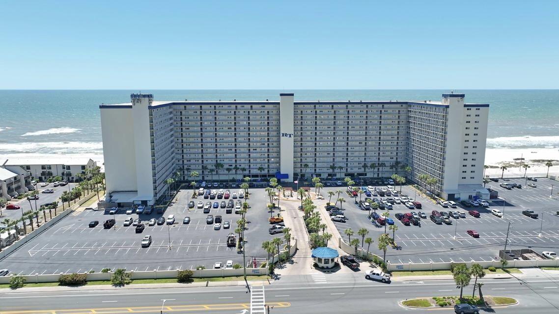 Welcome to paradise at Regency Towers 121! This coveted first-floor condo offers the ultimate in beachfront living, with direct access to the courtyard area just steps from the pool, tiki bar, and grill. And with the sugar-white sands and emerald-green waters of the Gulf of Mexico just a few more steps away, you'll be living the coastal lifestyle you've always dreamed of. Inside, you'll find three full bedrooms and two full bathrooms, providing plenty of space for family and guests to relax and unwind. A full-size washer and dryer inside the condo make laundry a breeze, while the fully updated kitchen boasts stainless appliances and quartz counters, perfect for preparing meals and entertaining.  The master bedroom and family room feature a closed-in patio overlooking the Gulf where you