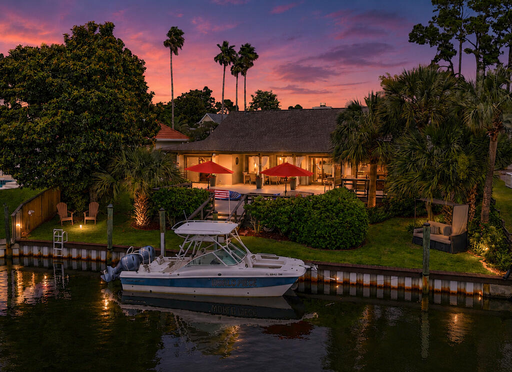 Welcome to 210 Marlin Circle, where coastal living and wellness come together for you to live the lifestyle you deserve. Set on a calm canal east of the Bonefish Bridge in Bay Point, this property is re-crafted by a medical doctor and yoga therapist, offering green to blue spaces, simple Gulf boating access, and restorative design. The soaring cathedral ceiling in the Great Room is anchored by a functional fireplace, creating a warm and inviting centerpiece. Just steps away, the wet bar features a custom granite waterfall countertop and is equipped with a beverage fridge and automatic ice maker, making it perfect for effortless entertaining. At the heart of the home is a Chemist-Style Kitchen, illuminated by skylights and framed by soapstone countertops. This thoughtfully designed workspace includes a touchless faucet, foot-tap to open rubbish cabinet, a combination convection microwave wall oven, and a six-burner gas cooktop with a pot filler. There's even a secret built-in spice rack that adds a delightful element of surprise. This one-level interior layout home includes four en-suites, one with a curbless shower for limited mobility, another ideal for children, and the third with a courtyard and private entrance for guests or caretakers. The primary suite has a Turkish-inspired steam shower equipped with mood lighting/speakers, a soaking tub, and a courtyard featuring a dual-temperature outdoor shower with a hot tub. The landscaped backyard serves as your launch for sunrise fishing trips, sunset sailboat cruises, diving excursions, spontaneous escapes to Shell Island, magical dolphin encounters, dining at Capt. Anderson's, and refueling at the full service Point South Marina. Back at your private dock, you're greeted by jumping fish, zoysia grass under your feet, and watercraft washing stations. There are many chill-out spots on property to choose from, including a native Southern Magnolia Tree, which provides a natural cooling sanctuary aligned with western facing sunsets to connect and unwind from the coastal breeze and lively birdsong. This property is move-in ready. It offers 70' of bridge-free private dockage, 30amp shore power, space for a boat lift or keep it open for a sailboat . There are dual laundry zones, air purification systems, HVAC serviced semi-annually since its 2020 installation including ductwork, smart thermostats, tankless gas water heaters installed in 2020 & serviced annually, intelligent irrigation, surround sound, surveillance, automated landscape lighting, dock lights and so much more. 210 Marlin Circle is where wellness meets wonder, and living becomes art. Schedule your showing today.