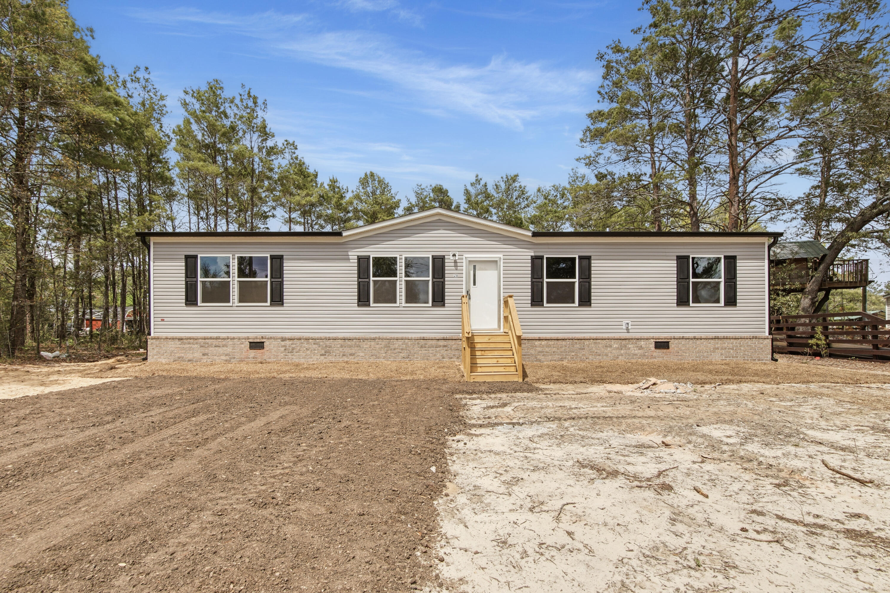 BRAND NEW construction home just completed at an accessible price point in DeFuniak Springs. Friendly floorplan allows for comfort and functionality. Featuring gutters, true brick skirting, and pilled pavement driveway, this home is upgraded from a lot model. Room sizes for allow for versatility for each family member to have their own space, for hobbies, or guests. Home is situated on a lot that is manageable, with NO HOA.