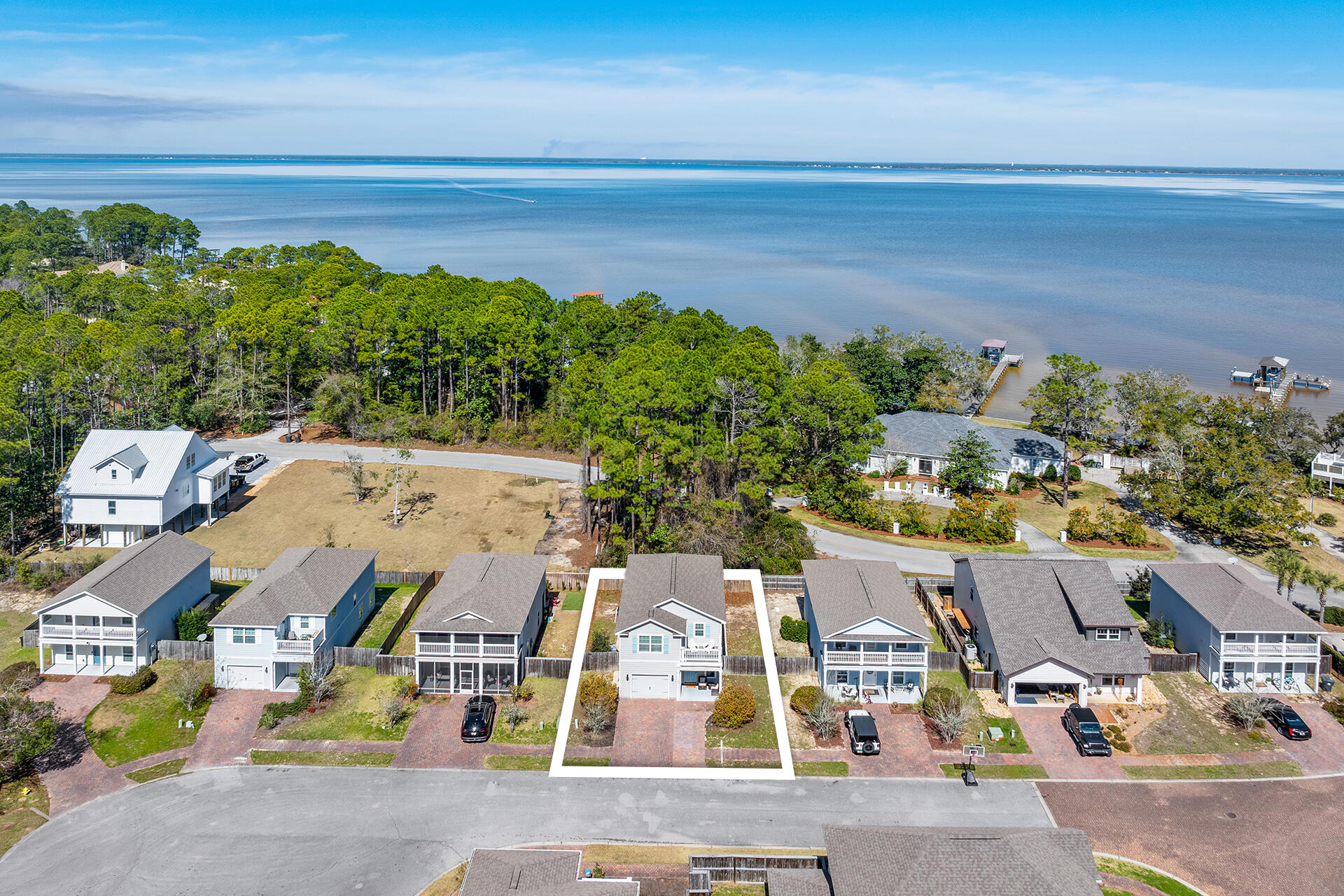Tranquility By The Bay is a charming coastal community located across from Choctawhatchee Bay in Santa Rosa Beach. With just 15 homes surrounding a beautifully maintained pool, it offers privacy and relaxed coastal living.

52 Tranquility is a well-maintained 3-bedroom, 2.5-bath home featuring engineered hardwood floors on the main level, luxury vinyl plank upstairs, and tile in all baths. The kitchen and bathrooms showcase stylish, low-maintenance finishes that blend comfort and practicality.

Enjoy sunrise coffee on the spacious sundeck or unwind at sunset.  Located near boat launches, white sandy beaches, upscale dining, boutique shopping, and entertainment, this home is perfect as a primary residence, second home, or investment opportunity.