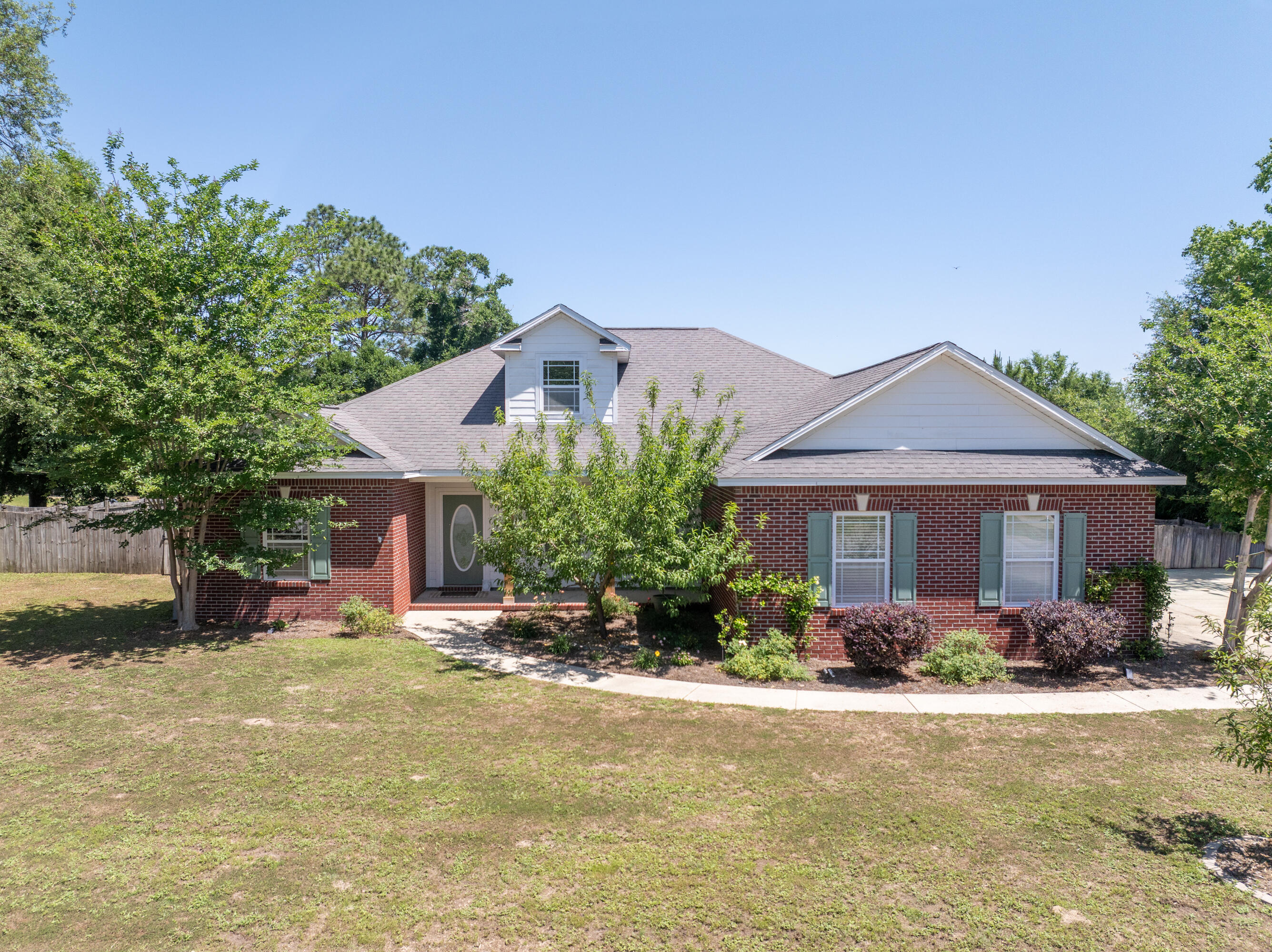 Assumable VA loan with an incredible rate of  2.75%. Welcome to this meticulously maintained 3 bed, 2 bath home nestled on a spacious 1/2 acre lot in an established Crestview neighborhood filled with mature trees and charm! From the moment you arrive, you'll notice the freshly landscaped yard featuring peach trees, blooming flowers, and plenty of room to enjoy your own little slice of homestead living. The backyard was designed to simply unwind outdoors, with a fully fenced yard, custom extended concrete patio with a shade sail, raised flower beds, a custom veggie wash station, and a thriving garden producing potatoes, watermelon, carrots, lettuce, green beans, herbs, blackberries, and more. There's a custom built chicken coop valued around $3,000 - elevated for durability - so yes, bring your chickens! Inside, the home is freshly painted throughout and full of character with vaulted ceilings and a dormer window which adds tons of natural light. Additional peace of mind comes with a transferable termite bond. This one checks all the boxes for anyone dreaming of homestead-style living with modern comfort - don't let this one fly the coop!