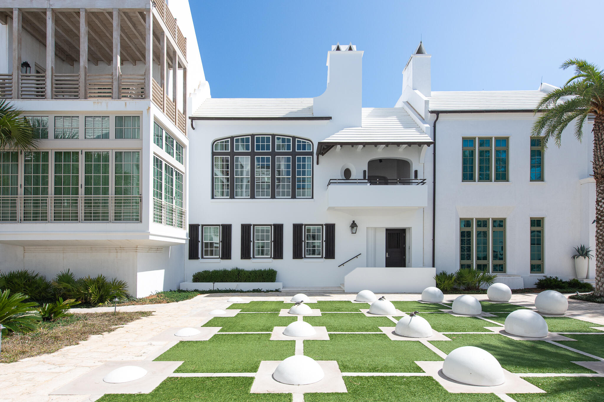 Discover the unparalleled luxury of 32 Kings Castle Court in Alys Beach, a remarkable home designed by renowned architect Gary Justiss. Nestled south of Scenic Highway 30A, this custom residence is perfectly positioned along the iconic Turtle Bale Pedestrian Path, leading directly to the pristine Gulf of Mexico. Gary Justiss's exceptional talent shines through in this four-bedroom home, which harmoniously integrates livability with interconnected private outdoor spaces.  This home epitomizes the Bermudan architecture that Alys Beach is awarded for.

The main living level is an entertainer's dream, boasting three distinct outdoor amenities. Enjoy a refreshing swim in the inviting pool with a sunning deck, dine alfresco in the screened patio featuring a summer kitchen, and unwind on the second-floor balcony loggia overlooking the Turtle Bale Pedestrian Path. This loggia, furnished for relaxation, offers stunning views of western sunsets and is appointed with an outdoor fireplace and TV. The seamless combination of French doors and bifold door systems invites the outdoors in, creating a cohesive living experience. The expansive kitchen, dining, and living areas are designed as one space, adorned with beautiful custom windows that capture abundant natural light while showcasing views of the acclaimed pedestrian path.

The primary suite serves as a personal oasis, outfitted with custom window treatments and designer tile work. The luxurious bathroom features a soaking tub nestled within a grotto, while a generously sized closet with custom cabinetry connects to a family office and workout room, all contained within the primary suite's envelope. Each of the three guest bedrooms offers en suite bathrooms, beautiful custom-built cabinetry, and walk-in closets, ensuring comfort and privacy for all guests.

Ownership of this extraordinary home includes access to all Alys Beach amenities, including the exclusive private owners' Beach Club. With its exquisite design and thoughtful features, 32 Kings Castle Court meets the needs of discerning Alys Beach property owners. This property is truly a must-see.