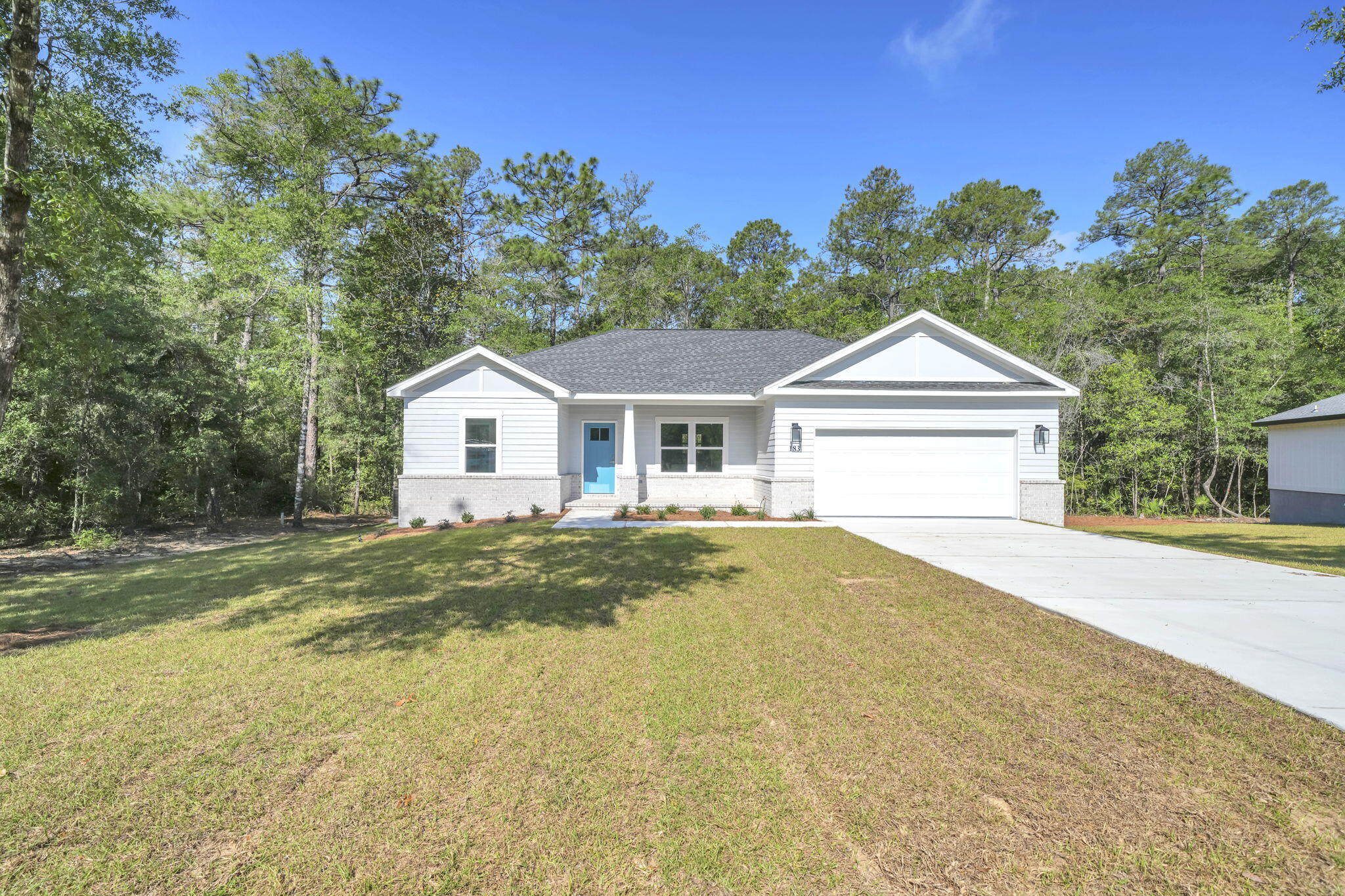 BRAND NEW CONSTRUCTION! IDEAL LOCATION!  MOVE IN READY!  This new home is perfectly situated in the community of Hunter's Ridge located directly behind Walton High School with close proximity to city parks and Downtown Defuniak Springs.  Hunter's Ridge boasts; underground utilities, countless trees, and public water/sewer.  Enjoy the comfort of the split bedroom floor plan. Interior features include; LVP (luxury vinyl plank) flooring in the main living areas, tiled bathroom floors, stainless appliances, solid surface countertops, high-grade mill work, custom shelving in closets/pantry, and a plethora of recessed, can lighting/designer light fixtures.  Exterior features; architectural brick and fiber cement siding, wooden tongue and groove stained entry ceiling at front porch, two-car garage, and 3 dimensional roof shingles.  Make 183 Hunters Ridge Drive your brand new Florida address!!