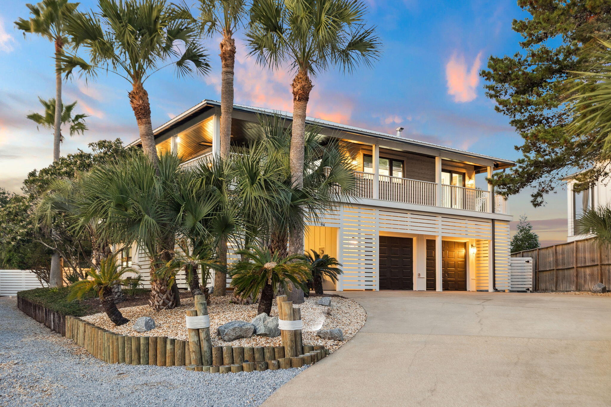 Extensive 'down to the studs' renovation in 2022 delivers a like-new home with a new metal roof, windows, doors, and siding, plus fully updated plumbing and electrical, a redesigned kitchen and bathrooms, new decking, LVP flooring, and more. Ideally located in the heart of Blue Mountain Beach, this fully furnished residence offers rental projections up to $297,900 and comfortably accommodates 20+ guests with parking for 15+ vehicles. Set on a rare 1/2 acre lot at one of the highest elevation points on 30A, it features Gulf views, expansive wraparound porches on every level, a private heated pool, outdoor game room and no HOA. With 6 bedrooms, 2 large bunk rooms, and 5 full baths, it is thoughtfully designed for large gatherings or multigenerational living. Inside, the upper level showcases an open-concept living and dining area anchored by a wraparound wet bar and a peninsula gas fireplace. High-impact glass sliders open to the expansive wrap-around porch, filling the space with natural light. The gourmet kitchen features quartz countertops, a gas cooktop, stainless steel appliances, a butler's pantry, and a charming breakfast nook with deck access for seamless indoor/outdoor dining. The upper floor also includes the primary suite and a studio-style bedroom, both with direct deck access, along with two additional guest bedrooms. The lower level serves as a true mother-in-law suite, including a bedroom with two walk-in closets, a large bathroom with a walk-in shower and jacuzzi tub, a second living room, a full kitchen, and a washer/dryer. This level also features two bunk rooms, an additional bedroom plus a full bath, and access to the two-car garage.

Experience exceptional outdoor living in the private backyard, where the wraparound covered porch offers multiple seating and grilling areas ideal for gathering and entertaining. The heated pool serves as the focal point of the space, surrounded by ample lounge seating perfect for relaxing with family and friends. The 800 sq. ft. heated and cooled game room provides endless fun with ping pong, Pac-Man, and video games, and offers incredible versatility for an at-home gym or studio. Popular local favorites like Blue Mountain Creamery, Cowgirl Kitchen, Blue Mountain Bakery, and the shops and dining of Redfish Village are all just a short walk away. Ideally situated just half a mile from the sugar-white beaches and a quarter mile from state park trail access, this home offers the best of Blue Mountain Beach living. YOLO boards convey. Don't