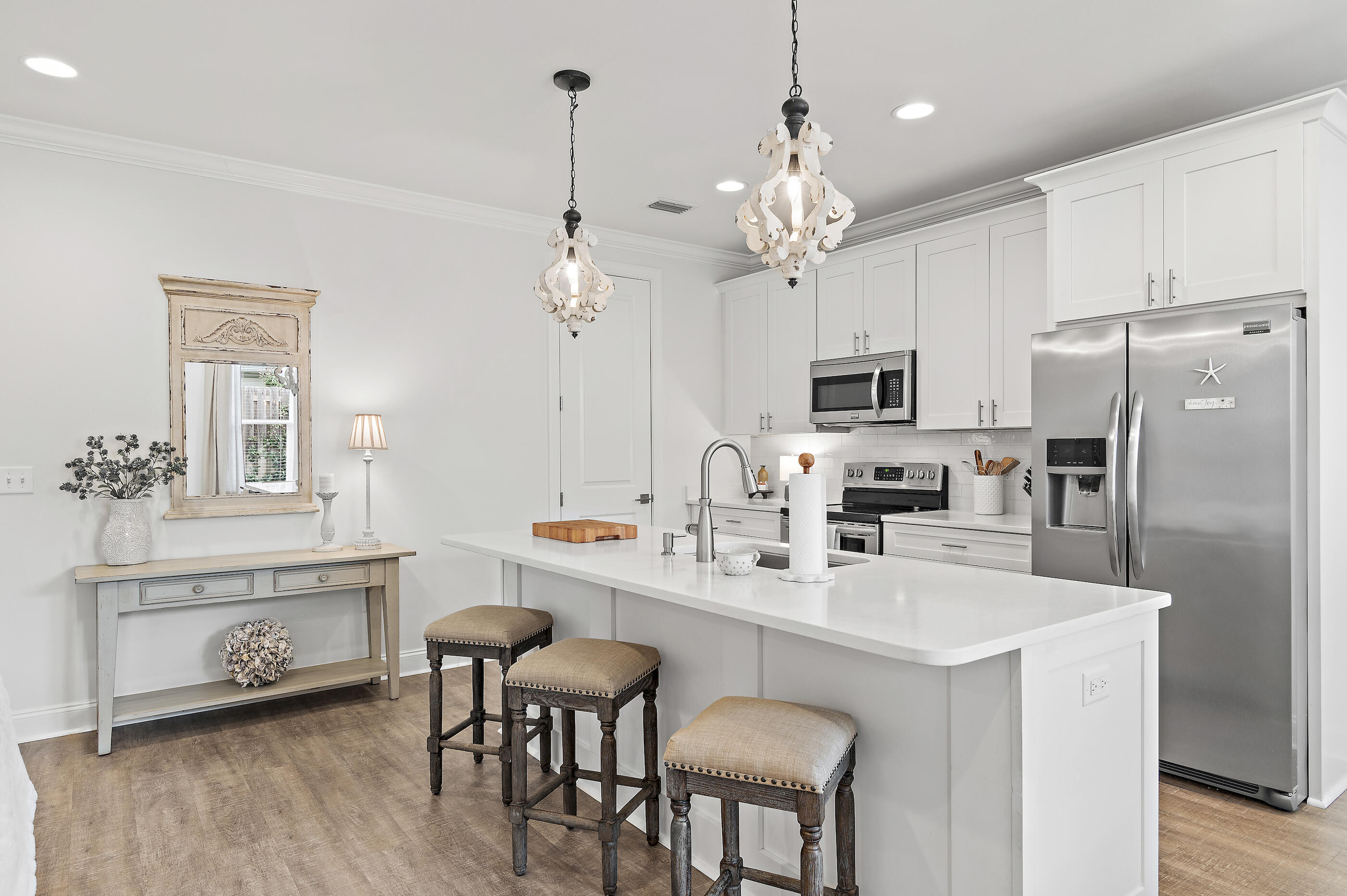 Tucked within highly desirable Church Street Village, this pristine 4-bedroom, 3.5-bath residence is a rare opportunity that blends thoughtful design with everyday livability.  Designed for flexibility and comfort, the home features two primary suites — one on each level — along with a rare 2-car garage, an exceptional find in the neighborhood. The interiors are bright, open, and impeccably maintained, showing beautifully from the moment you step inside. A private backyard creates the perfect backdrop for morning coffee, quiet evenings, or effortless entertaining. Residents enjoy amenities including a pool, fitness room, community room, and playground, all just minutes from the white-sand beaches of South Walton, golf, tennis, pickleball, scenic trails, state parks, Sacred Heart Hospital,