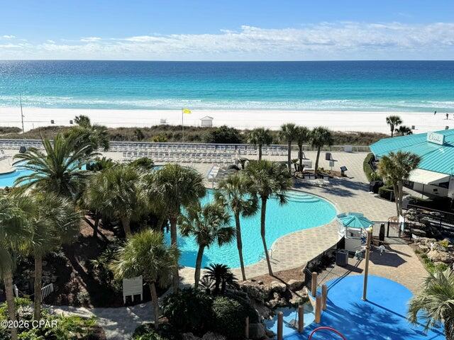 This is unit 509 in iconic Tower I for sale at Edgewater Beach & Golf Resort in Panama City Beach, Florida. A seaside 2-bedroom condo with an incredible resort-style view over the grand lagoon pool to the white sand beaches and emerald waters of the Gulf. One of the most popular floor plans available and completely remodeled!! Used as a second-home, but can be rented short-term. The private balcony has brand new sliding doors to the living space and comfortable, quality furniture sets ready for relaxing. A spacious living room features shiplap ceiling, new furniture and soothing coastal tones. Everyone's favorite, the beach view owner's suite, promises maximum sunshine through the floor-to-ceiling windows and allows access to the balcony. The owner's bathroom has been modified to an open space with tiled walk-in rain shower, owner's closet, and barn doors. Throughout the condo there is a lot of new: LVP flooring, doors, fixtures, faucets, wired smoke alarms. AC 2016, water heater 2018. The kitchen is stylish with quartz, natural pendant lighting, breakfast bar, and dining area. All of the appliances and washer+dryer are new; as is the kitchen favorite, a farmhouse sink. The guest bedroom offers two queens and has direct access to a bathroom. Enjoy private and secure beach accesses, heated pools, hot tubs, and sun decks. The food at Ocean's Restaurant is fantastic, there's a poolside bar, and market serving Starbucks. The Kid's Club is a blast with a splash pad, arcade, and planned activities. Owners enjoy unlimited golf, pickleball, basketball, tennis, and shuffleboard at the sports club. There's also a gym and Bella Salon services are available by appointment. You can walk to dining, entertainment, and shopping right across the street. Rest easy with gated entrances, 24-hour security, and building-side parking. There are electric charging stations and a lot designated for RV, boat, Jet ski, and trailer parking. Edgewater is pet-friendly for owners, and the dog beach and park are just minutes away. Plus, the resort is centrally located, just down the road from the popular Pier Park entertainment center and many local attractions. Reach out today for more information on this active resort lifestyle!